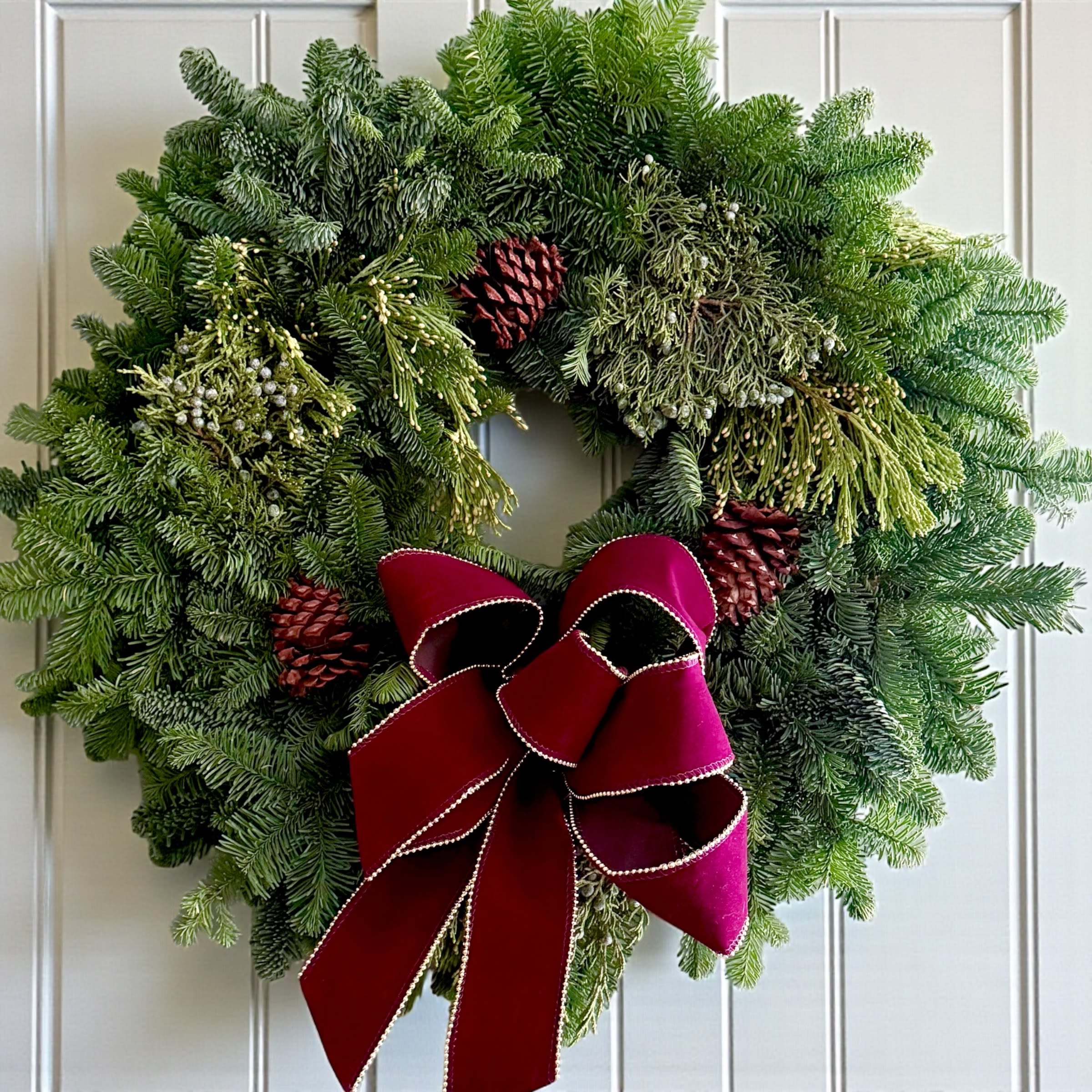 Fresh winter Wreath  - A beautiful fresh evergreen wreath measures 22” in diameter and full of mixed evergreens! It smells amazing and we added a velvet dark red bow to it. Great for lasting into January. 