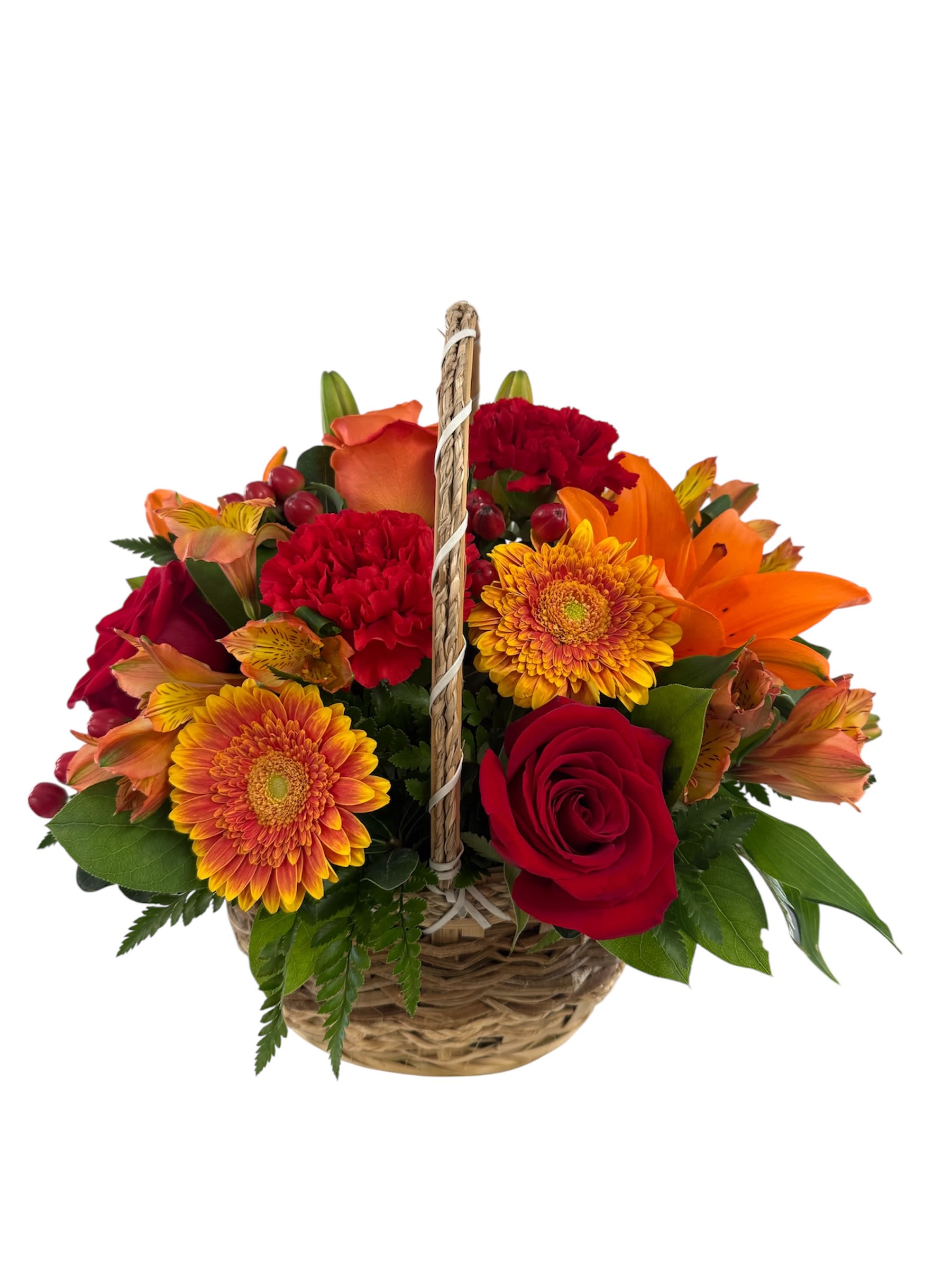 Autumn Basket - A mix of rich, warm colors like red, orange and yellow. With flowers such as roses, lilies and gerber daisies designed in a rustic woven basket.