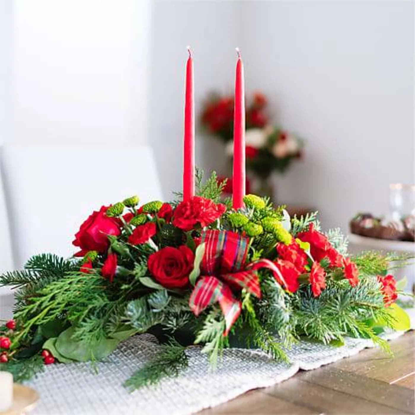 By The Candle Light - Let time fly By the Candlelight centerpiece as new holiday memories are made. What better way to commemorate the joyful homecoming than with classic red roses and lush evergreen accents