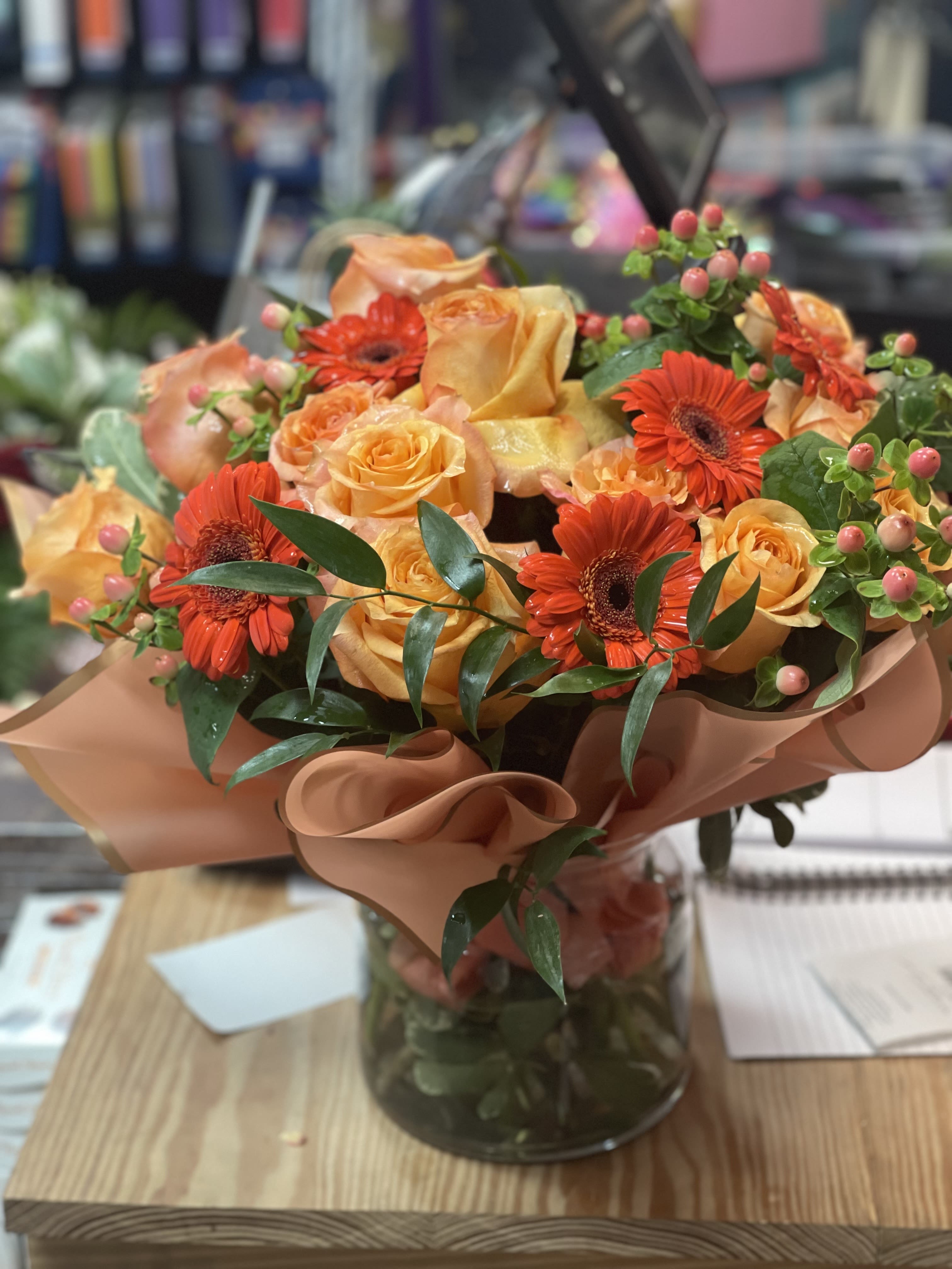 Citrus Burst  - Fresh, vibrant, and full of energy, our Citrus Burst bouquet is a cheerful splash of color designed to brighten any moment. Featuring sunny yellow roses that radiate warmth and joy, paired with bold orange gerbera daisies for a pop of playful color, this bouquet captures the zest of a summer morning. Accented with lush greenery for a natural, balanced touch, Citrus Burst is perfect for celebrations, thank-yous, or simply sending a little sunshine someone’s way.