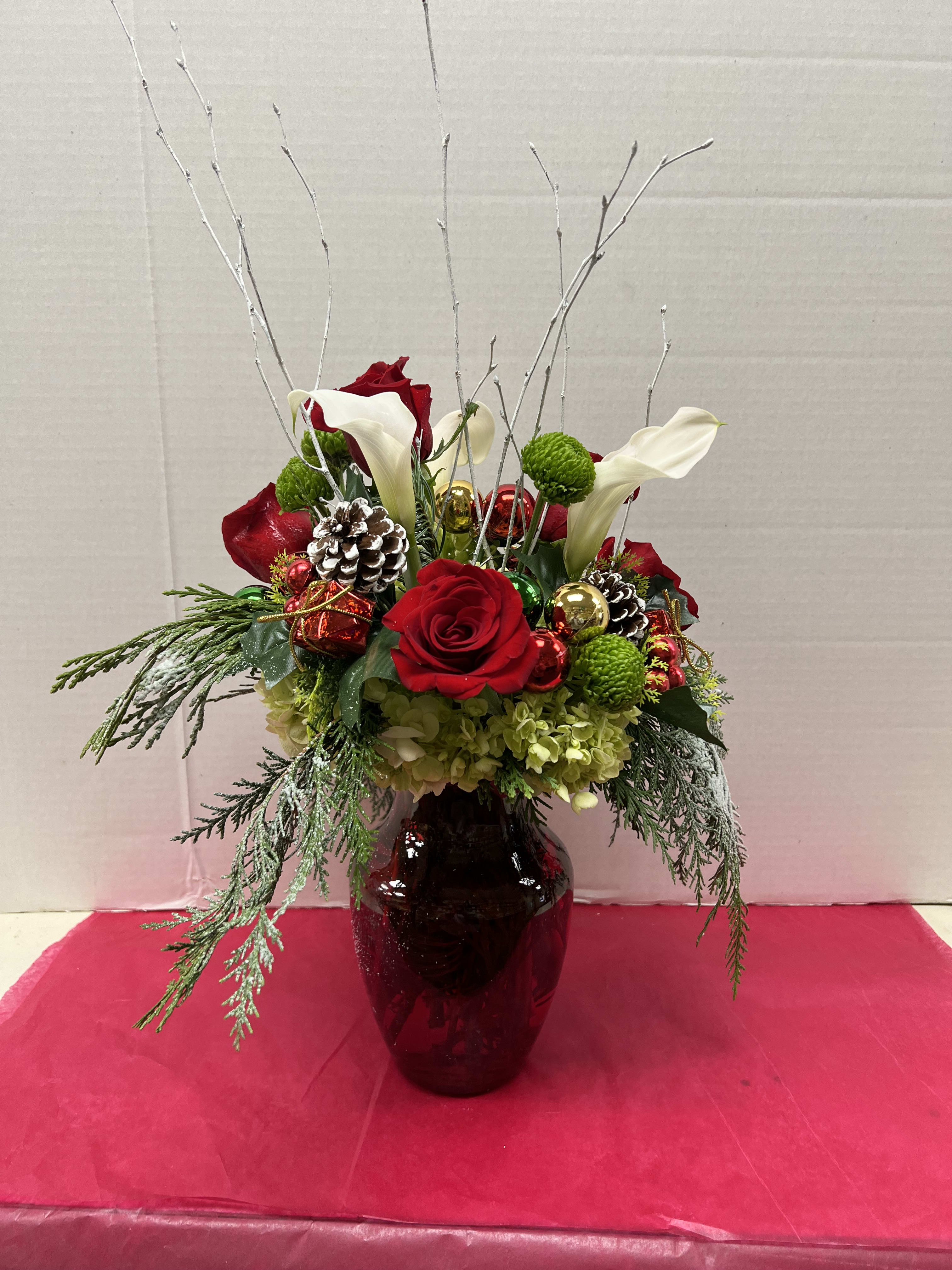Merry and Bright  - This Christmas bouquet stays true to its name! Merry details including Christmas ornament balls, Christmas greens are mixed with bright green button chrysanthemums in a jolly red vase. Lush roses and mini callas add to the seasonal splendor.