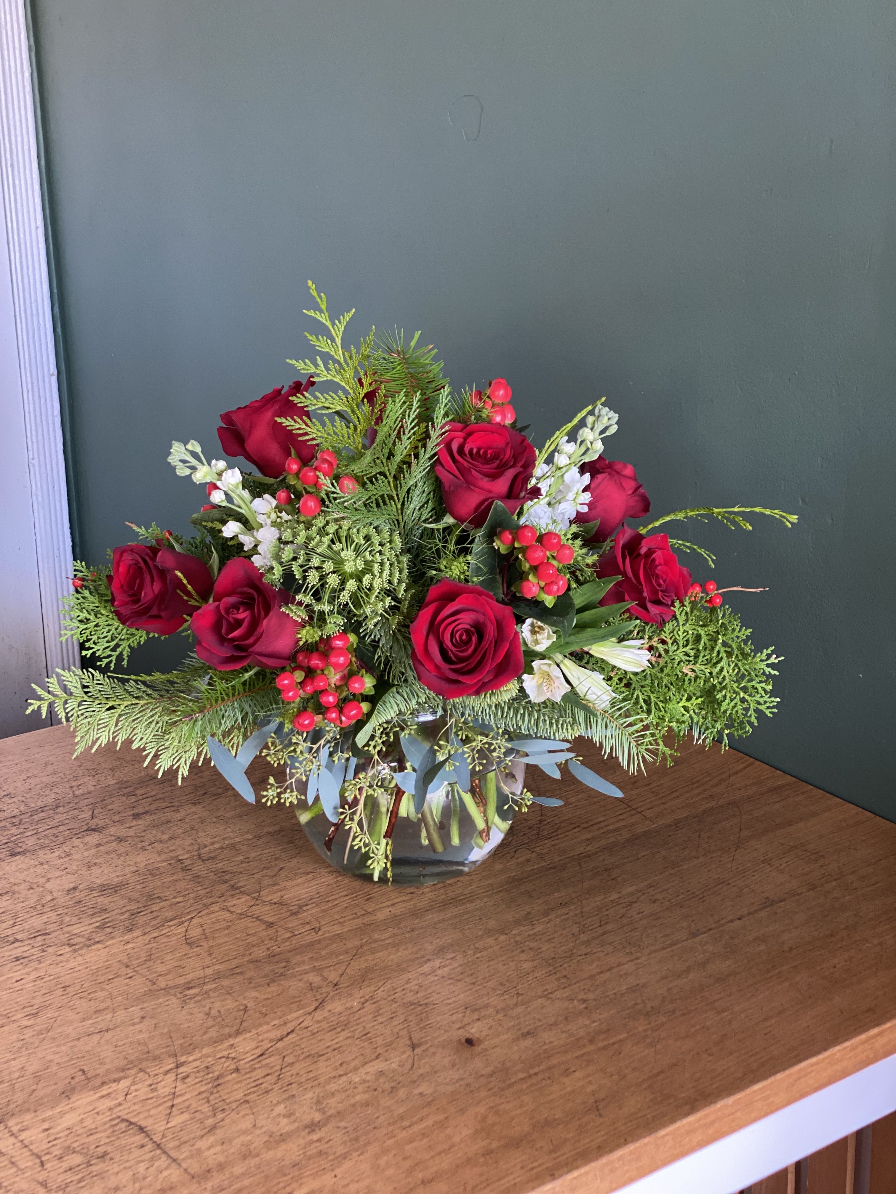 Holiday cheer  - A festive arrangement featuring roses, dendrobium orchids, Queen Anne's lace and mixed fir - spreading holiday cheer