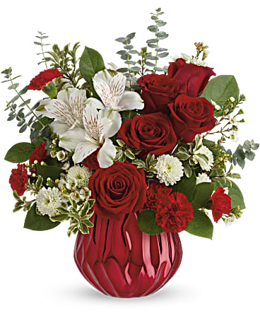 Heart Shine Bouquet - Send a truly enchanting gift this Valentine's Day with this delicate red rose bouquet, presented in a swirling ceramic vase with sparkling metallic finish. This lovely arrangement features red roses, white alstroemeria, miniature red carnations, white button spray chrysanthemums, white wasflower, spiral eucalyptus, pitta negra and lemon leaf. Delivered in the Enchanted Gem cylinder. Orientation: All-Around 