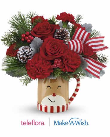  Send A Hug Reindeer Wish Bouquet - Overflowing with festive blooms, this adorable reindeer delivers your holiday wishes! The glazed ceramic mug adds a whimsical touch to your seasonal sipping. From November 14 through December 31, 15% of the purchase price from all Teleflora's Send A Hug® Reindeer Wish Bouquet and Send A Hug® Merry Reindeer Tree sales will directly help grant children's wishes with Make-A-Wish.* *Total campaign donation to Make-A-Wish to equal $250,000. This delightful bouquet showcases red roses, red carnations, miniature red carnations, dusty miller, douglas fir, and white pine. It's beautifully presented in Teleflora's Send a Hug® Reindeer Wish Mug, perfect for spreading holiday cheer. Orientation: All-Around 