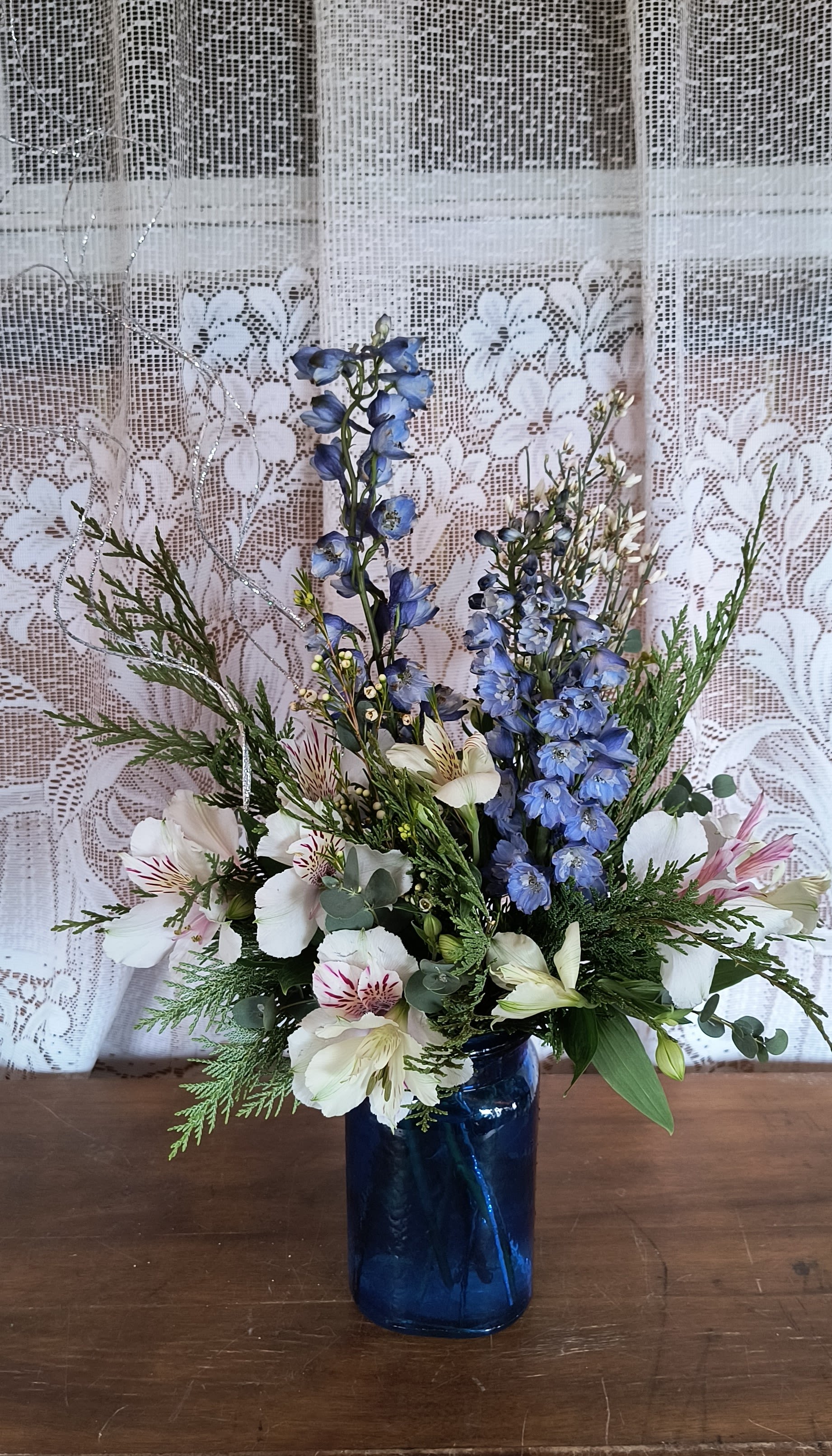 Frost - This tranquil medley of sky blue and cloud white flowers is like an oasis of calm. An enchanting winter floral gift and a wonderful way to celebrate Hannukah or even a seasonal birthday. Actual flower varieties may vary.