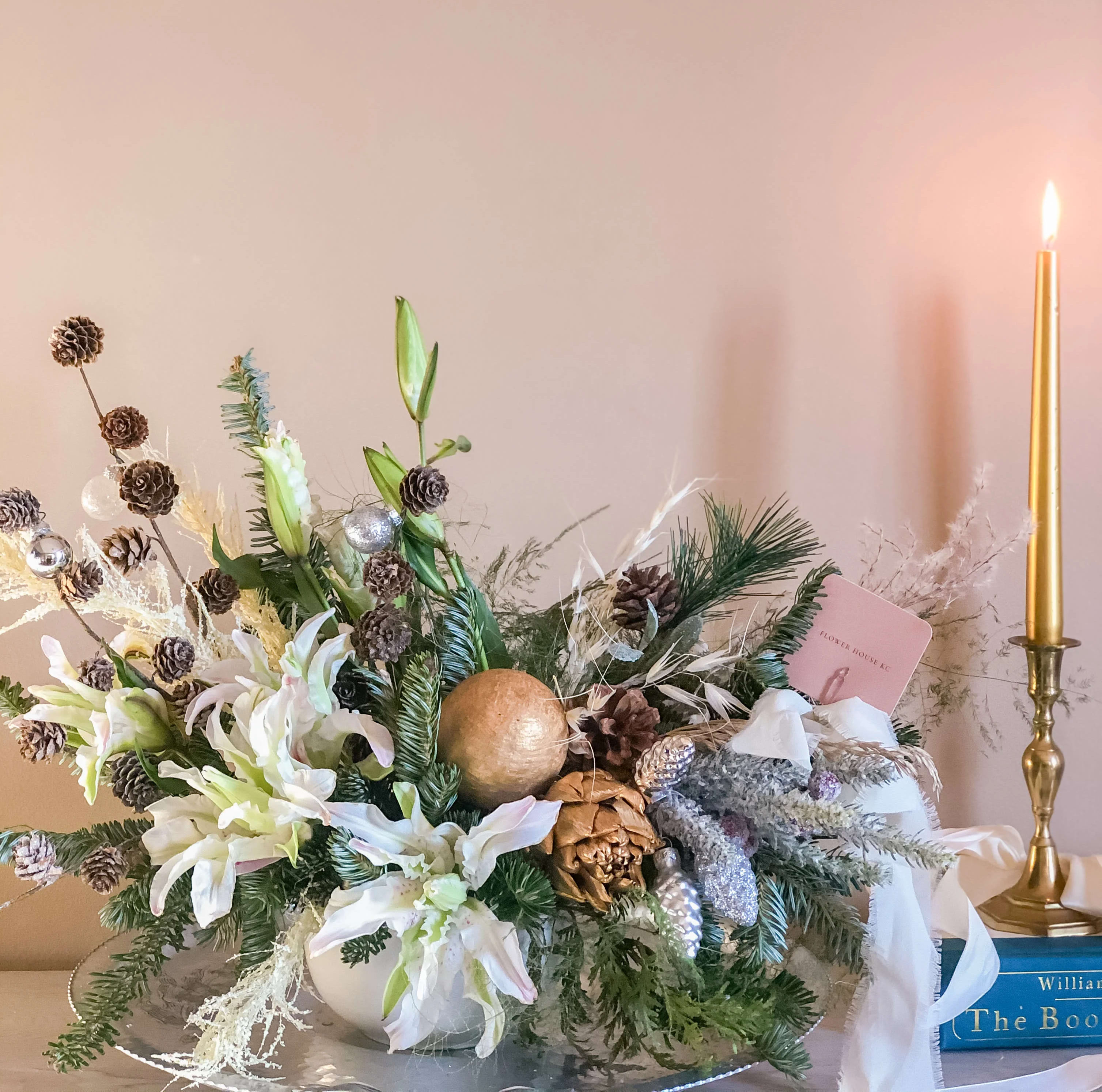 Winter Centerpiece  - Dress up your holiday table with this fresh Christmas arrangement.  Featuring gorgeous white flowers, pinecones, ornaments and evergreens in a ceramic bowl.  