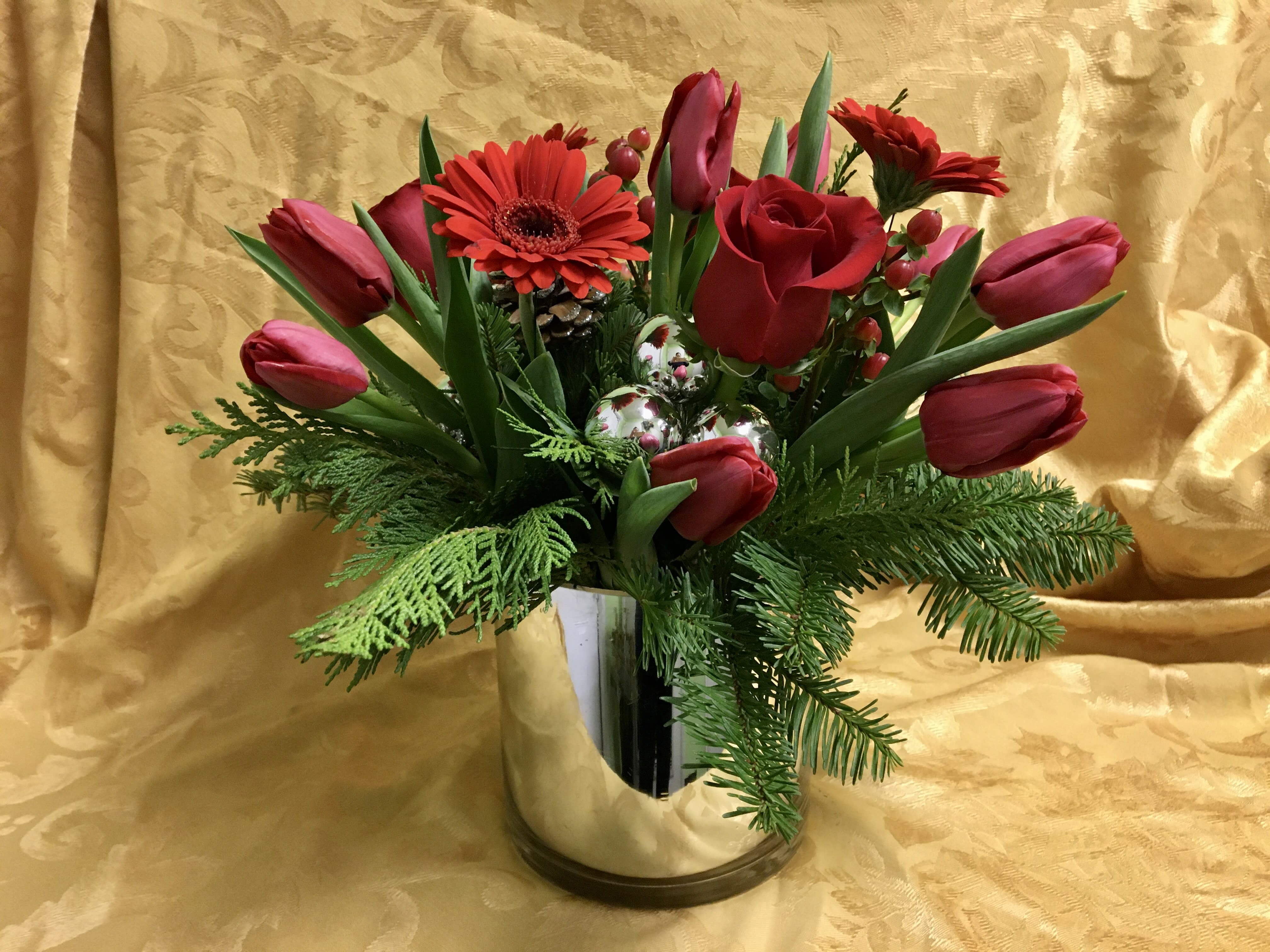 WINTER RED - A BEAUTIFUL &quot;6 SILVER CYLINDER WITH RED TULIPS,ROSES,GERBERS AND BERRIES. SILVERS BALLS AND PINE CONES. * PLEASE NOTE THIS IS A LOCAL DELIVERY ONLY *