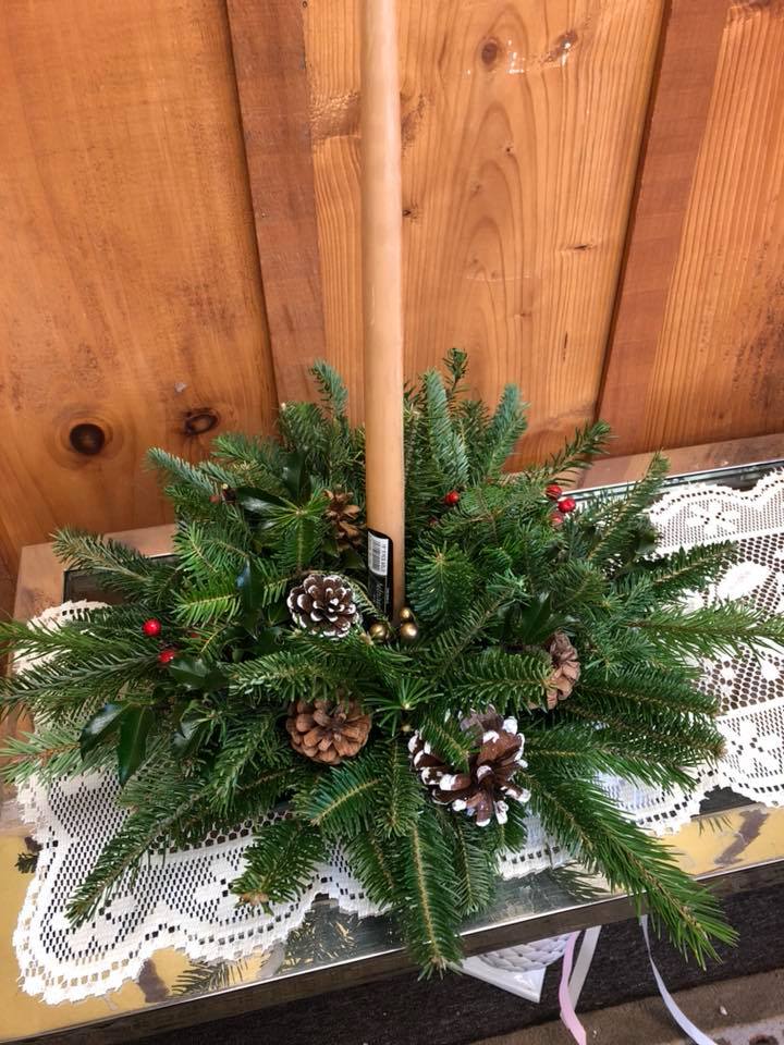 Simply Sweet Holiday Centerpiece - The perfect centerpiece for any table. Adorned with mixed evergreens, berries, pinecones, and a candle. 
