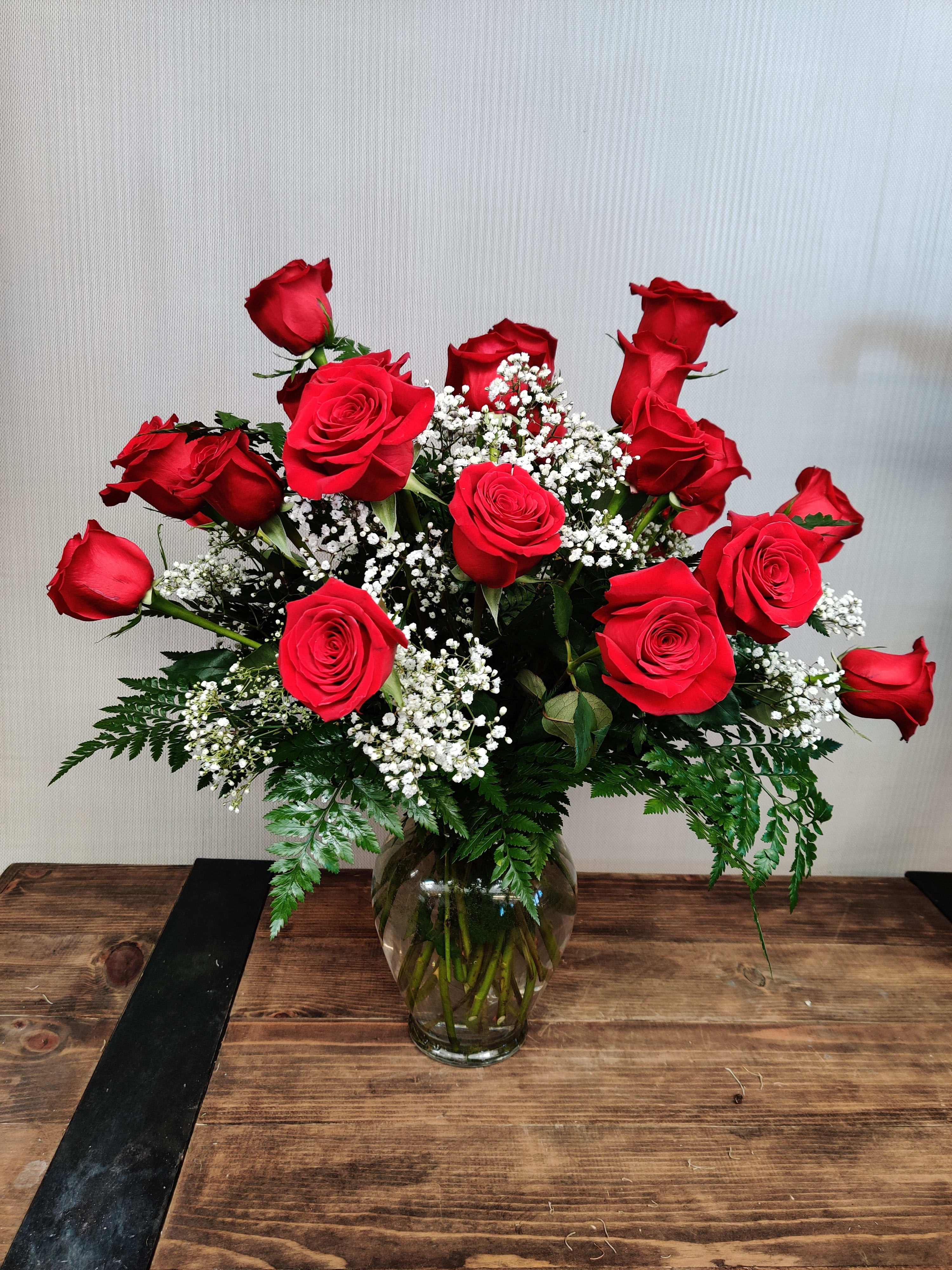 2 Dozen Roses Vased (Call for color availability if other than red) - Traditional romantic roses in a glass vase with greens and babies breath