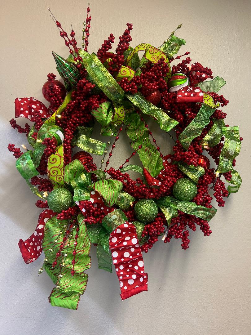 Berry Christmas Wreath - This traditional Christmas wreath is ready to make your area bright! It comes with battery operated lights. Measures approx. 22&quot; all around. 
