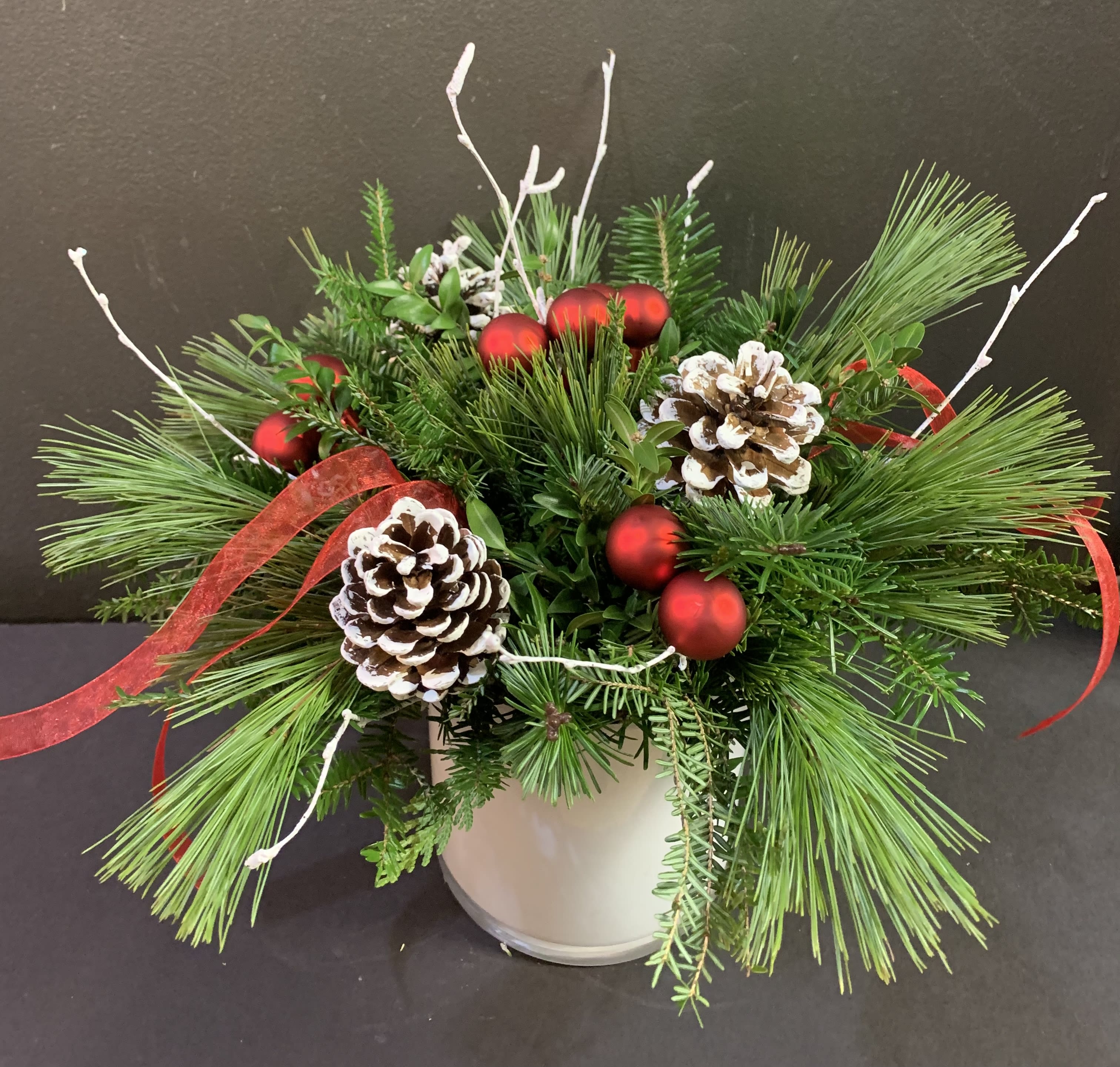 Holiday greens  - Beautiful vase overflowing with seasonal greens, pinecones, berries and ribbons. Long lasting option for the home. 