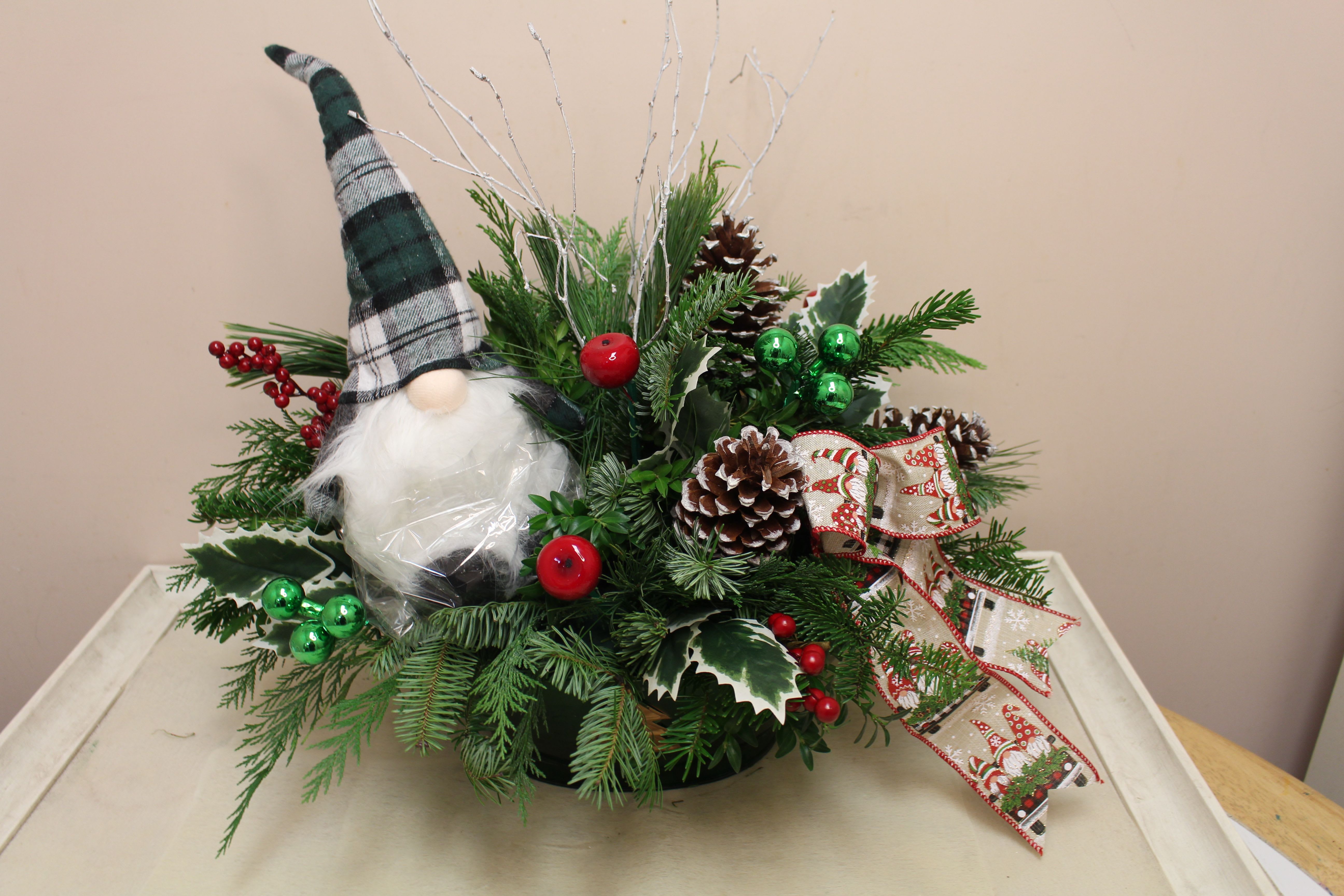 Jerome the gnome  - Jerome the gnome sits among evergreens, loving this long lasting arrangement.  You can take Jerome out every year!