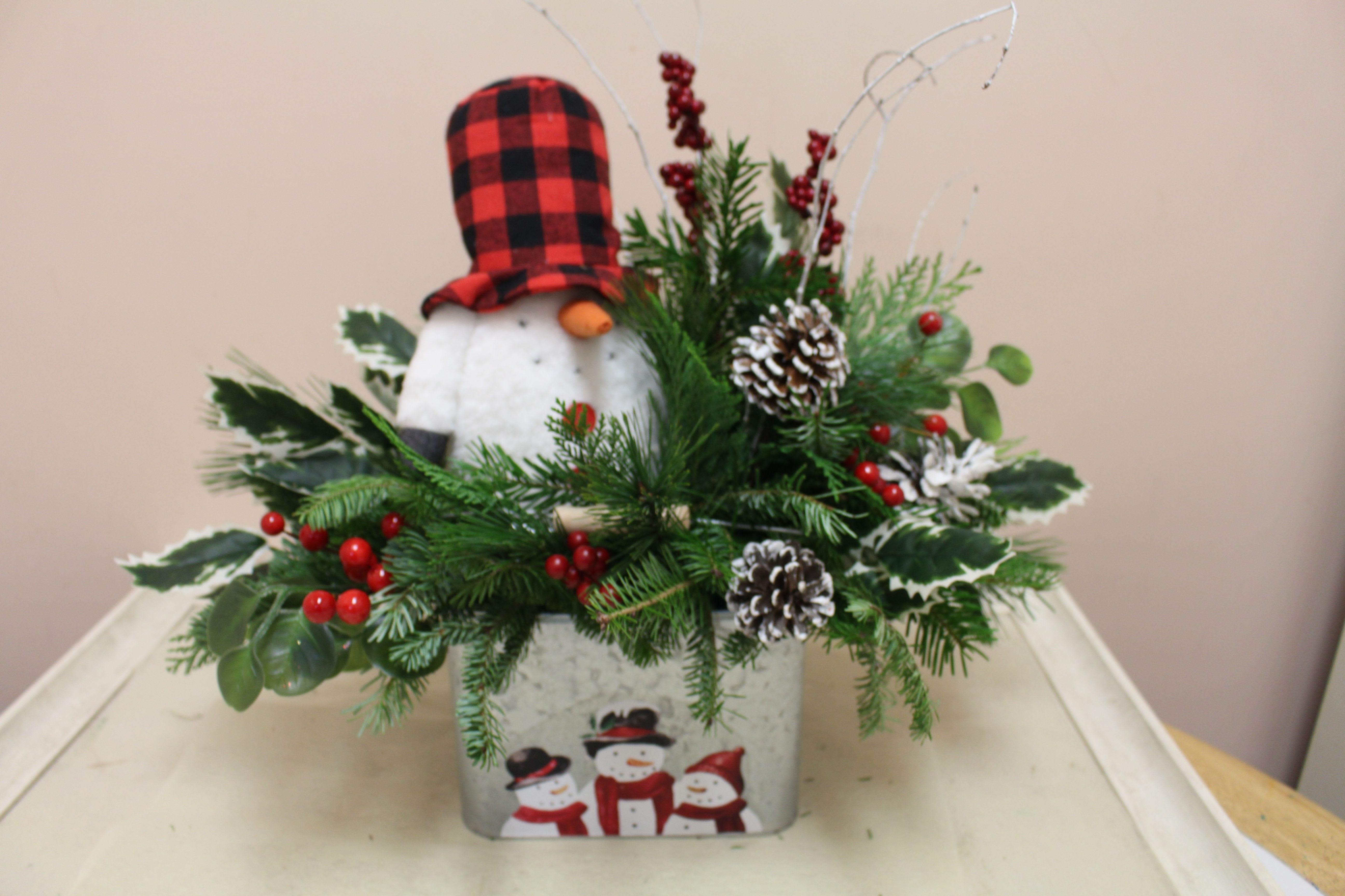 Chillin' in the woods - frosty just chillin' among the evergreens.  Long lasting arrangement and you can take frosty out year after year!