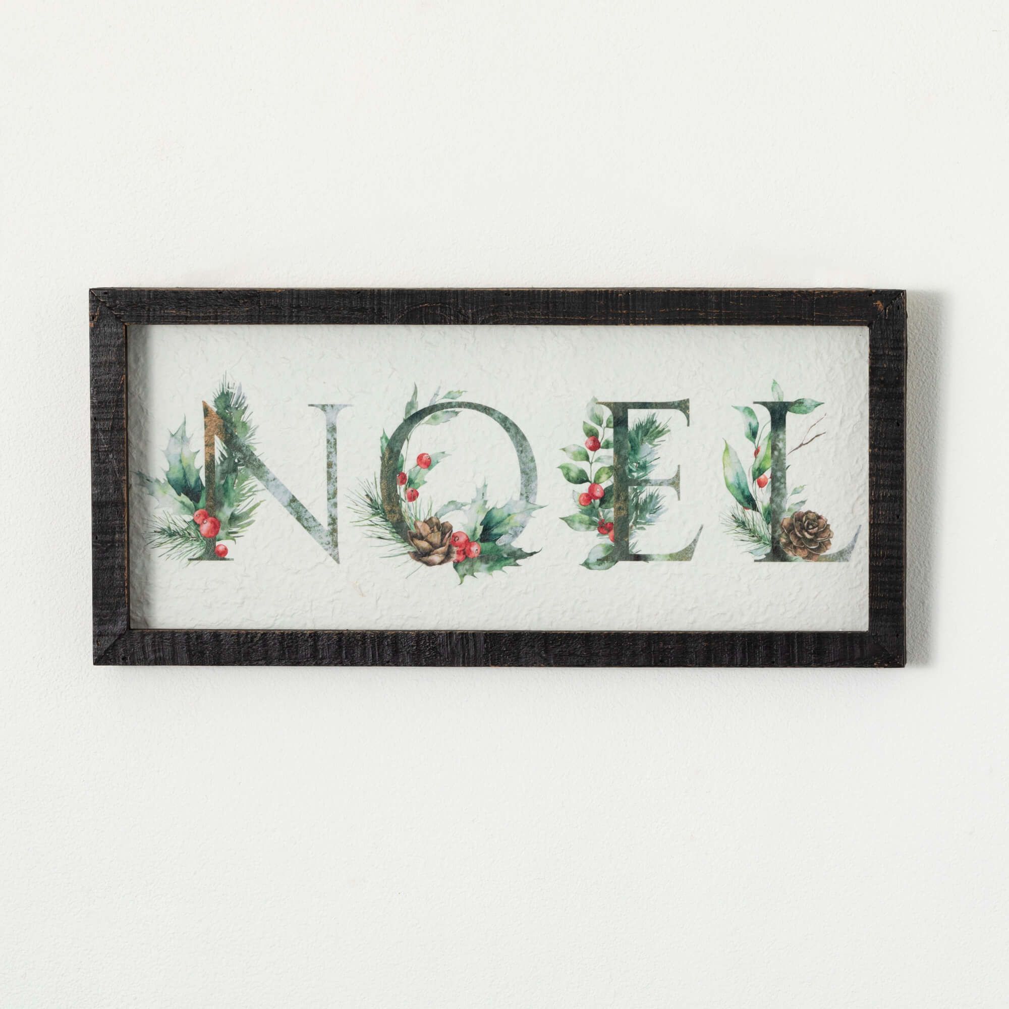 HOLLY NOEL WALL DECOR - Add a warm spirit of Christmas to your space. Featuring the word Noel, this classic yet stylish design complements all home styles while adding a touch of traditional Christmas magic. Eye-catching in size, this decorative wall art is the perfect size to elevate a mantel, bookshelf, or entryway without overwhelming smaller spaces. Hang it up and instantly feel the spirit of the season.  22"L x1.25"W x10.25"