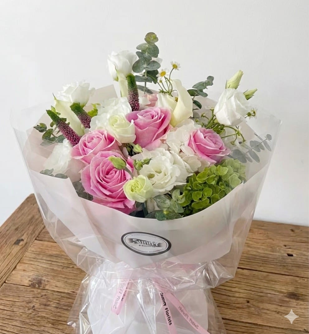 Pastel Garden - This pastel-colored handtied bouquet includes beautiful pink vandal roses, complemented by white hydrangea, white calla lily, and white lisianthus. Standard size pictured. Larger sizes available.