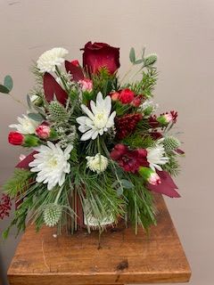 Holiday Candle Bouquet - A customer favorite, this flower arrangement sits on the lid of one of our fragrant Chestnut Hill Candles. We will use fresh seasonal flowers and fresh fragrant greenery to complete the bouquet! It's 2 gifts in one! 