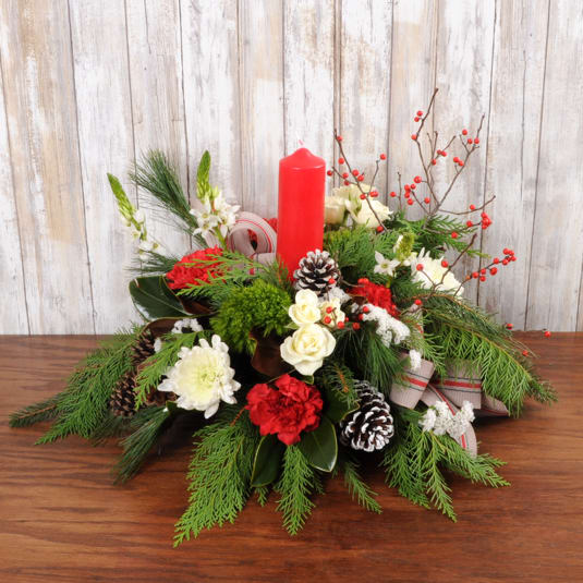 Candlelight Christmas - Rounded candle centerpiece perfectly filled with holiday flower blooms in red and white with pinecones and wintergreens.