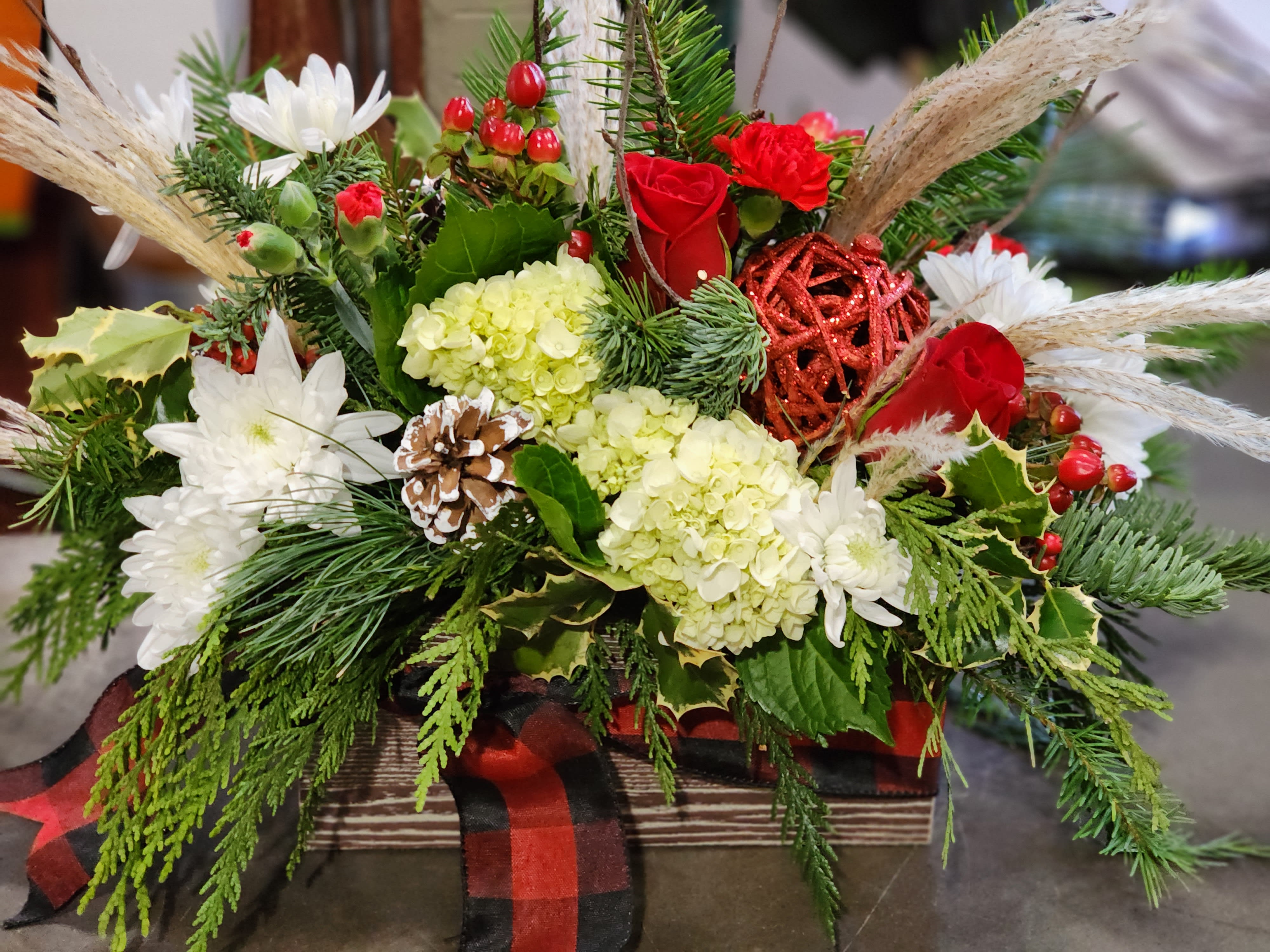 In the meadow we can build a snowman - Wooden box tied with ribbon for the scarf effect. Evergreens, berries pinecone, holly, grasses and branches adorned with beautiful hydrangeas, roses and mums to complete the in the meadow feel of the season. 