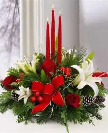Triple Candle Centerpiece - This full and lush floral centerpiece overflowing with lilies, roses, pinecones, and holiday trim comes with 3 taper candles.  Perfect for your holiday party or dinner.  Long lasting winter evergreens will make your house smell like a fresh cut Christmas tree.