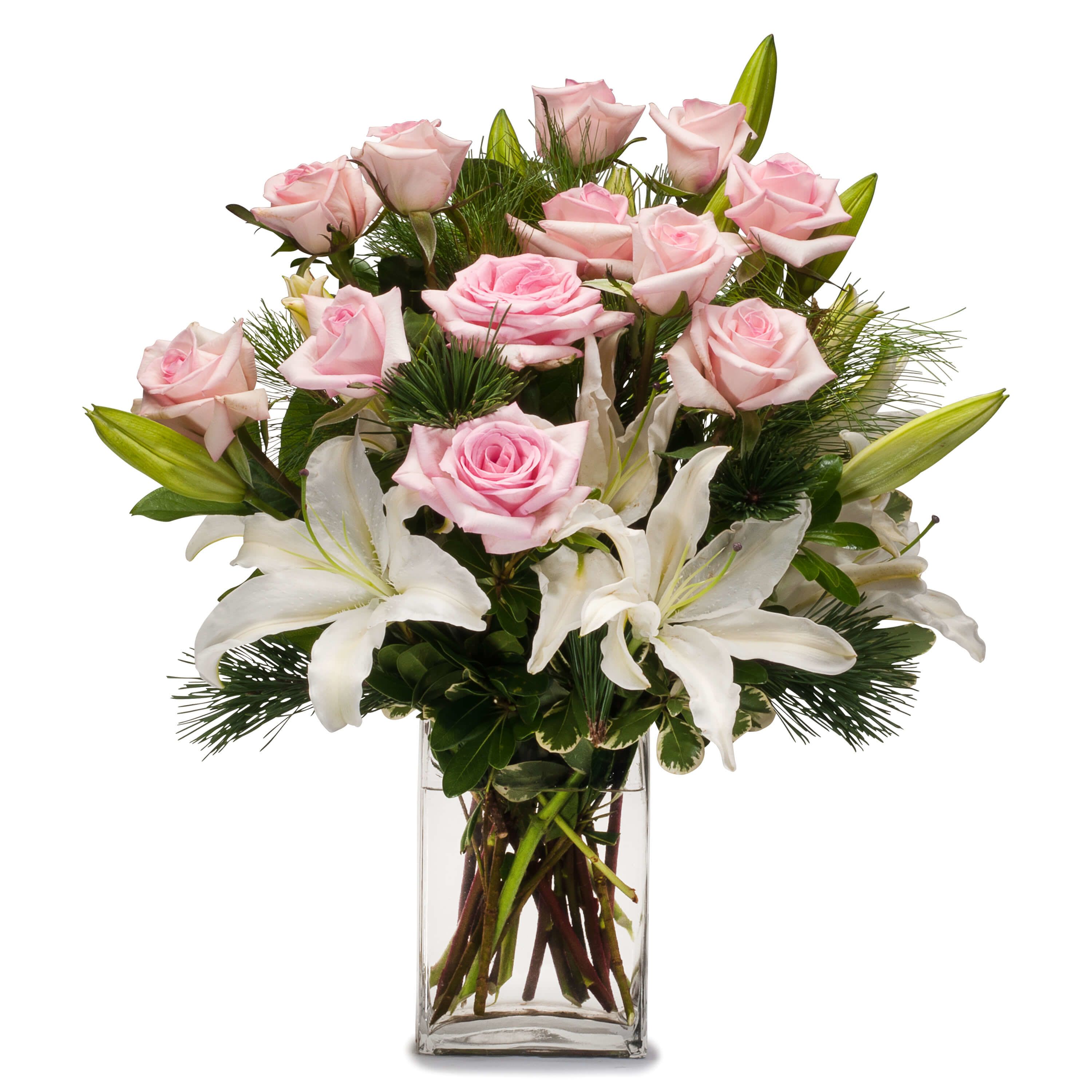 Christmas Kisses Bouquet - This gorgeous arrangement of white lilies and pink roses accented with evergreen is a great choice to celebrate pure joy or pure love.
