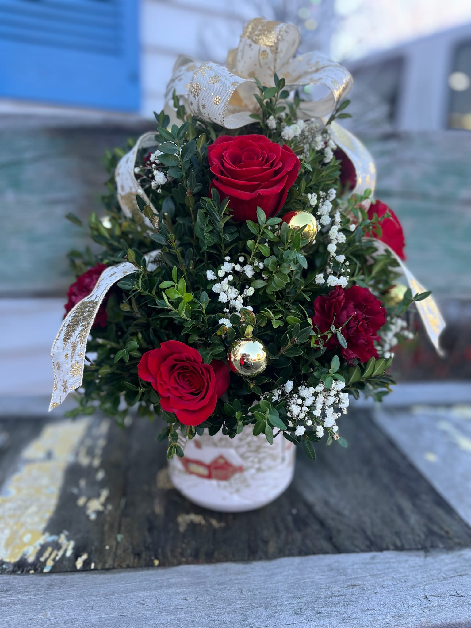  Christmas Elegance Boxwood red - Beautifully decorated boxwood tree with red roses and carnations designed in a red mercury cylinder vase, accented with upscale ribbons and gold balls