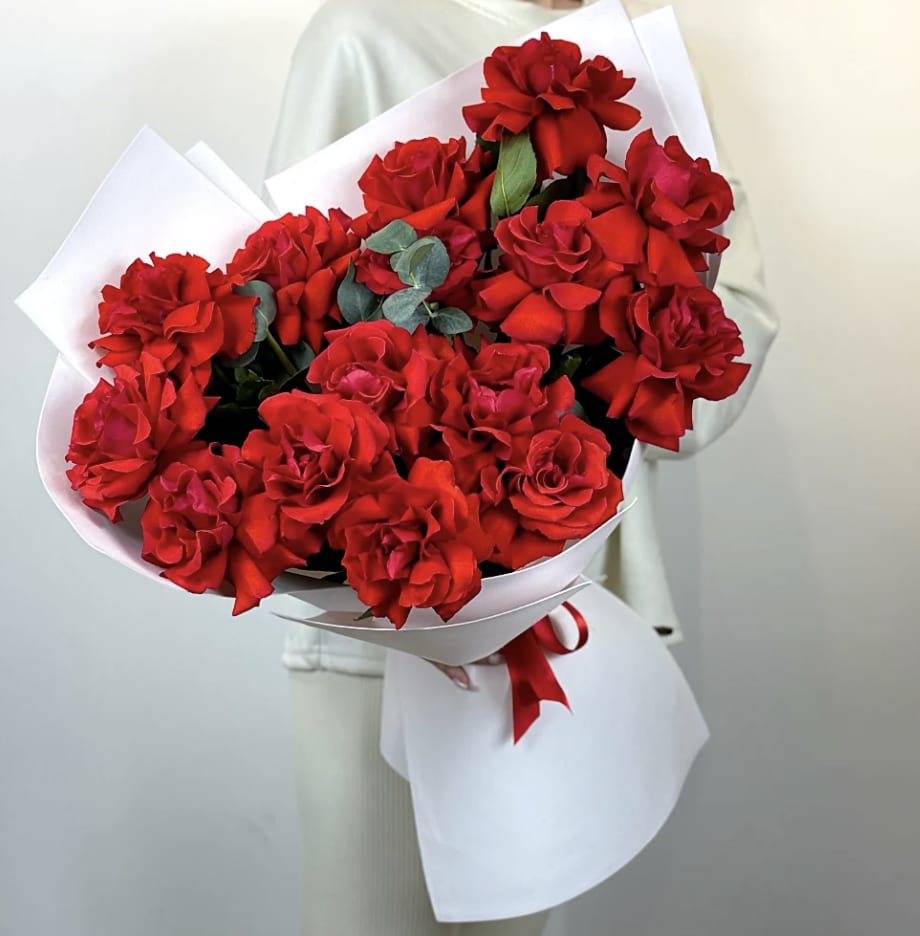 Open Red Roses - This Red bouquet of deep red roses is the embodiment of bold affection- modern, unapologetic, and fiercely romantic. Each bloom unfurls with velvety richness, radiating passion and confidence, while the sculpted, monochromatic palette brings a refined sense of luxury. Wrapped (call if you want the bouquet in a vase), in paper and tied with a slender red ribbon, it creates a striking contrast: purity embracing intensity, softness holding fire. The result is a bouquet that feels cinematic- powerful yet elegant, dramatic yet beautifully controlled. Designed for the moments when you don't whisper love- you declare it.  Perfect for Birthday's, Anniversaries, grand gestures, luxury gifting, or ay occasion deserving a show- stoping floral statement.  Standard: 1 Dozen Deluxe: 2 Dozen Premium: 3 Dozen