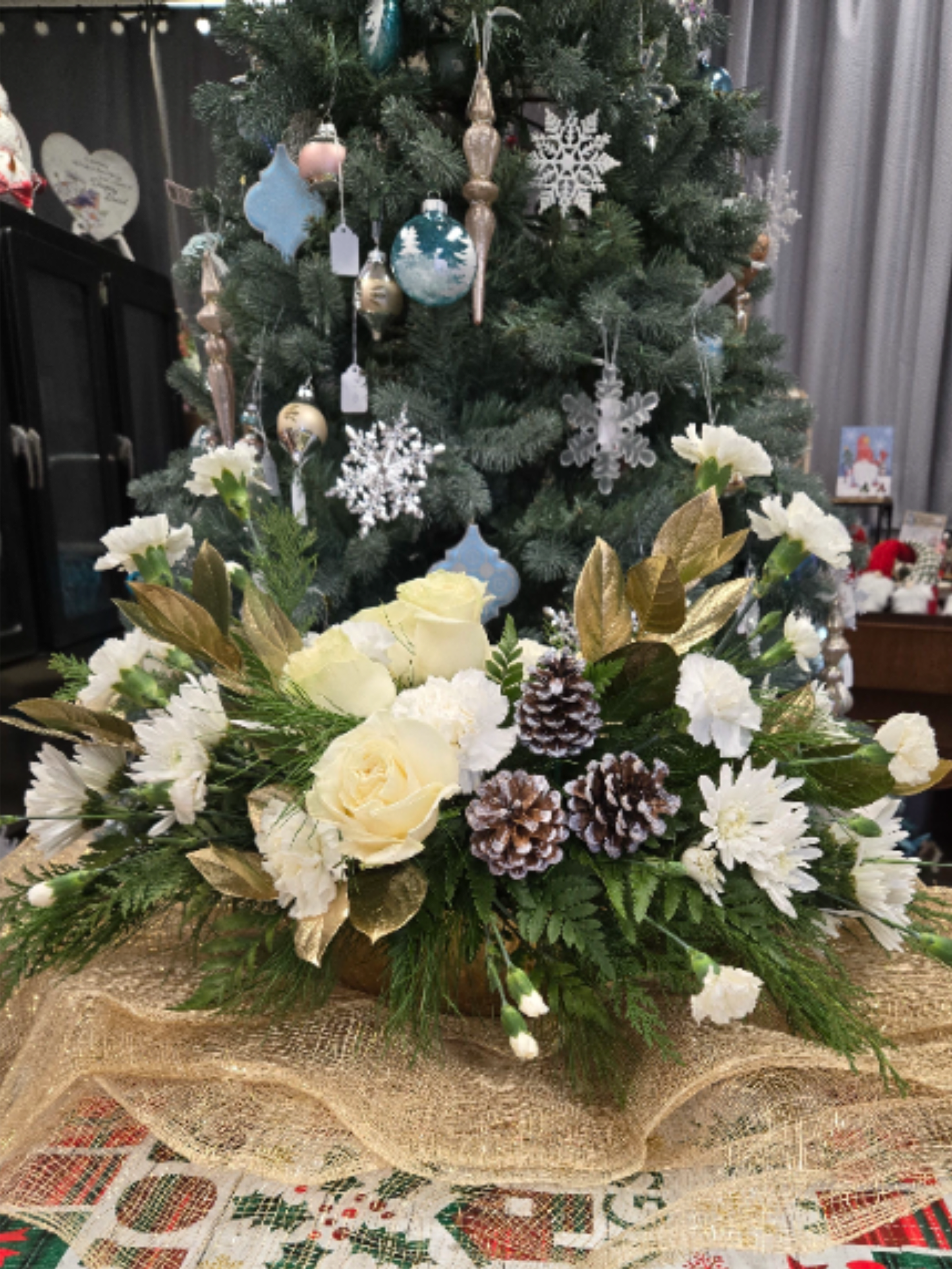 Golden Cheer - A Gold bowl filled with Christmas pines and white flowers brings elegance to any Holiday celebrations