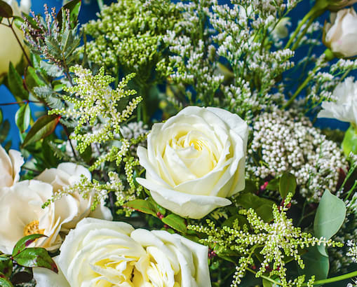 Designer's Choice WHITE CHRISTMAS WRAPPED ARRANGEMENT (White And Textural Greens- Airy And Layered) - Layers of winter white and textural greens for a sophisticated, neutral palette. A secondary color can be requested when placing your order if you would like a complement a color theme.
