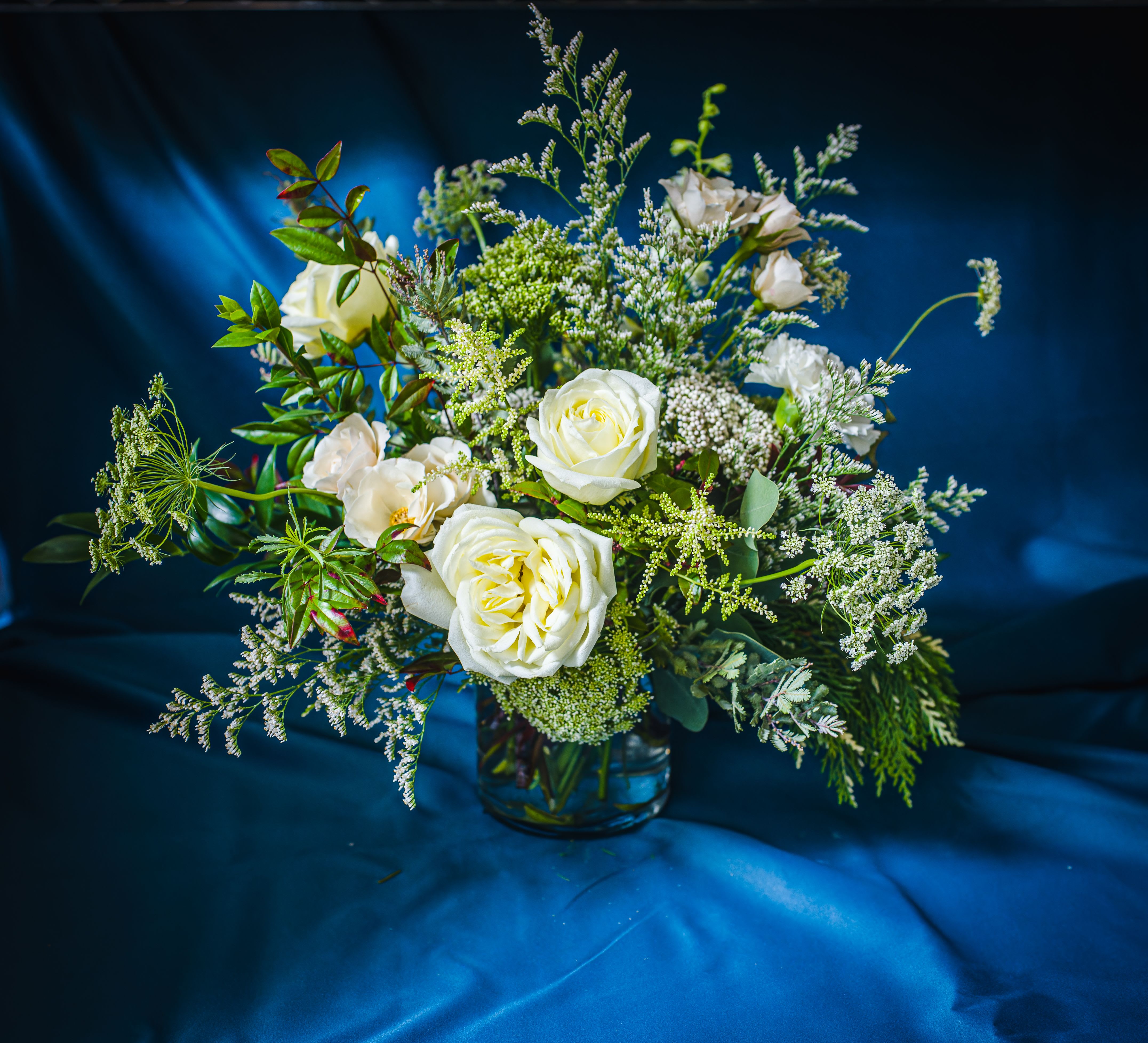 Designer's Choice WHITE CHRISTMAS VASED ARRANGEMENT (White and textural greens- airy and layered) - Layers of winter white and textural greens for a sophisticated, neutral palette.  A secondary color can be requested when placing your order if you would like a complement a color theme.