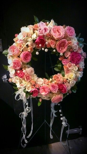 Remeber Her Wreath - sympathy wreath of shades of pink and cream roses in varying varieties and shapes accented with chiffon ribbon and pearls on an easel