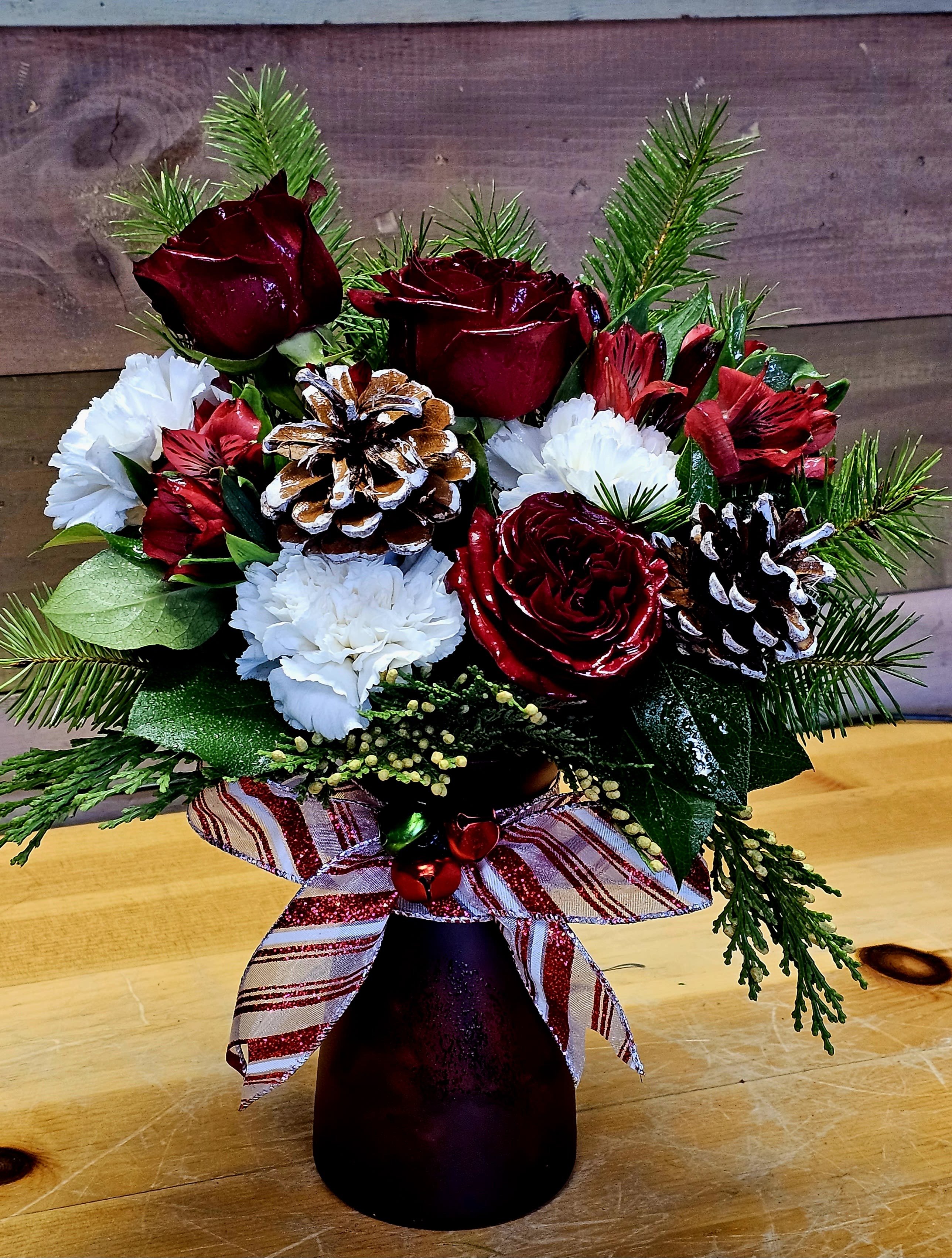 Holiday Cheer  - Want to wish your loved a joyous holiday season. Send this perfect gift of Holiday Cheer. You will smell the  wonderful pines that are added to enhance the holiday season. Flowers my change upon availability. 
