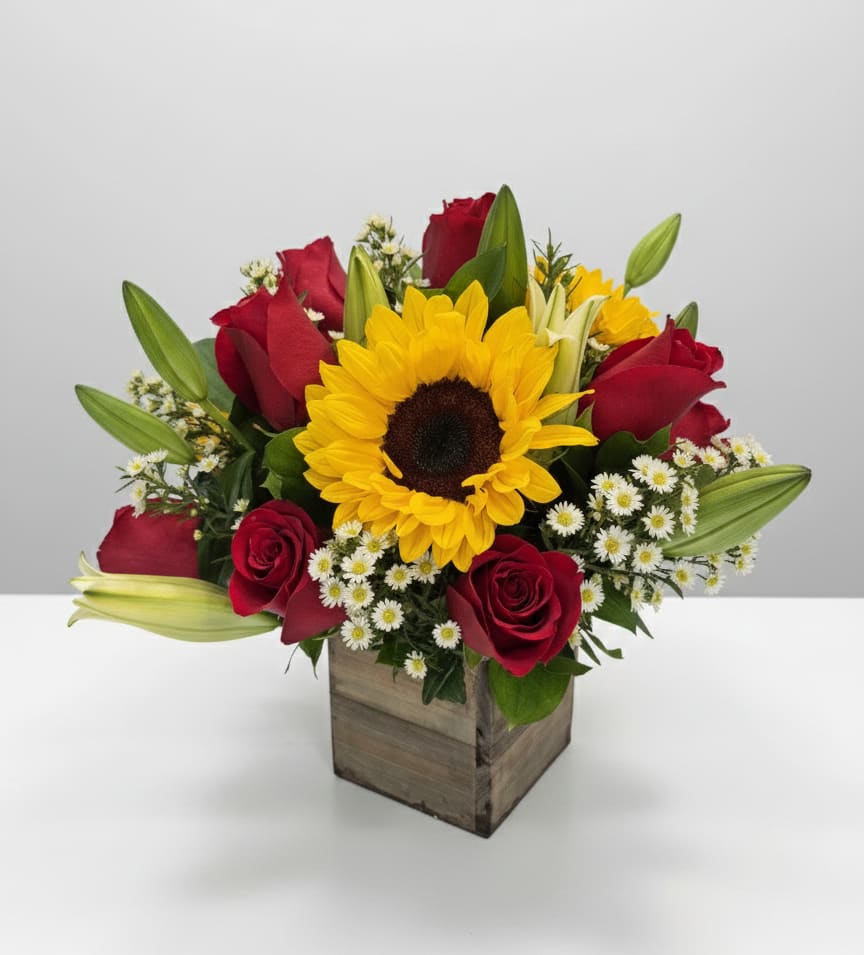 Elegance - Elegance : A vibrant celebration of color and warmth. This exquisite arrangement combines the bold and cheerful presence of the sunflower with the deep elegance and passion of velvet red roses. Presented in a rustic wooden box, it's the perfect gift to brighten any space and express joy, admiration, and love. Give the gift of sunshine and romance in a single, beautiful gesture!" 