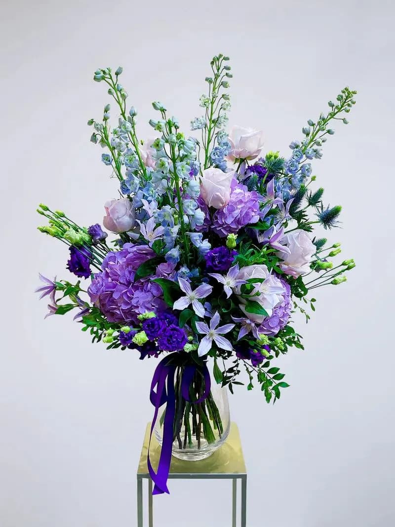 serenade  flower bouquet  - This gorgeous flower bouquet is a blend of fresh seasonal flowers in shades of purple and blue, orchestrated to perfection. Let these beautiful flowers serenade your senses and bring joy to your loved one's heart.