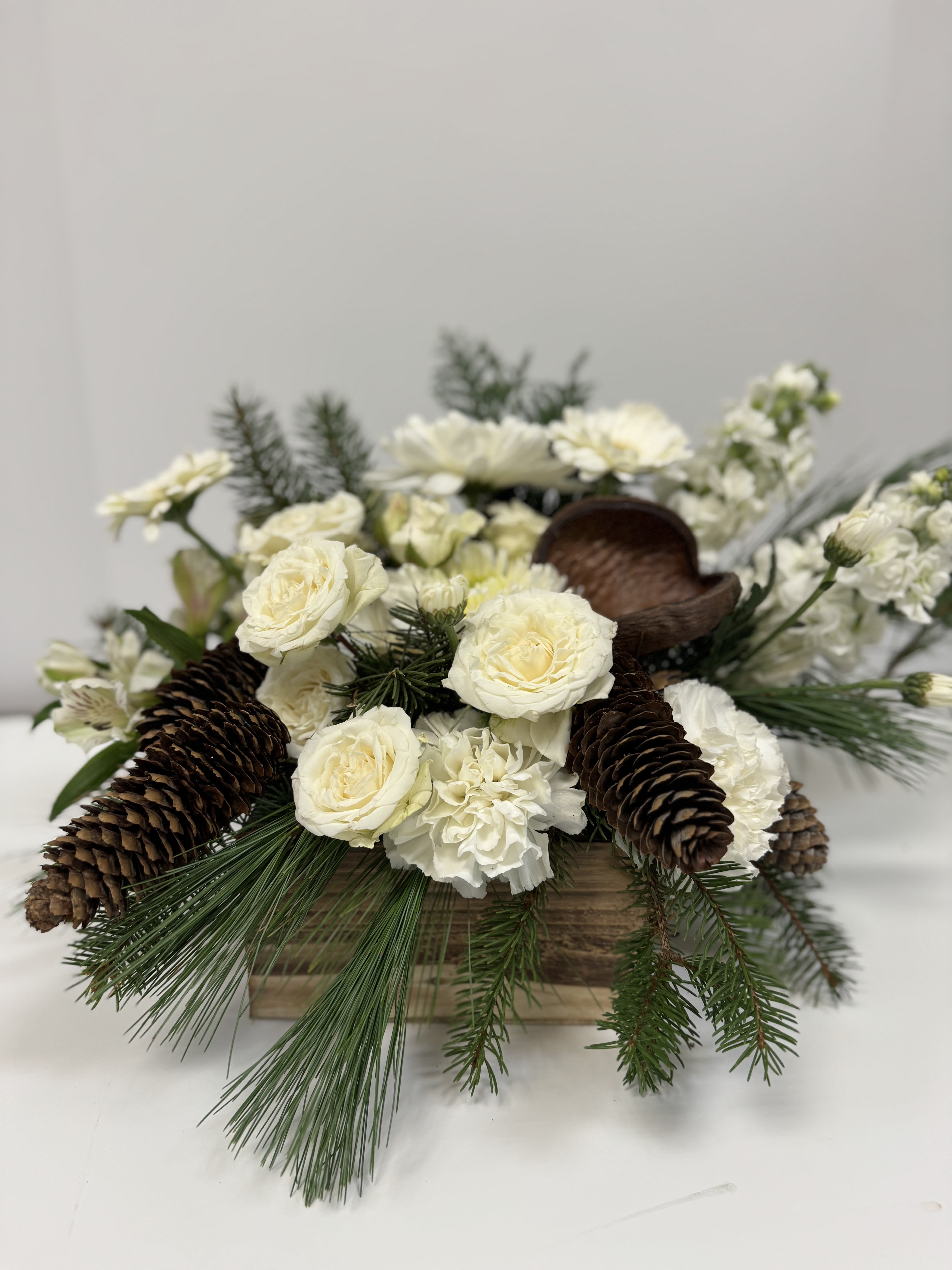 White winter - Seasonal white florals, pine cones, and berries to celebrate the beauty of winter.