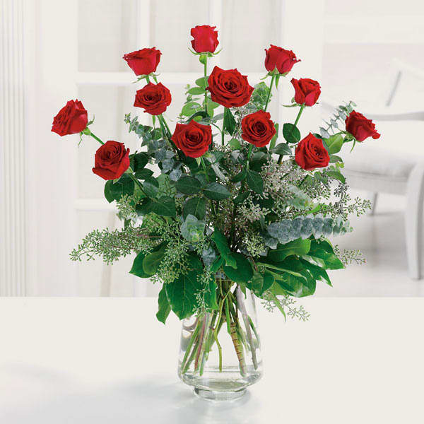 The Perfect Dozen - A dozen red roses are always perfect, always savored. Designed with seasonal foliages in a clear glass vase. 
