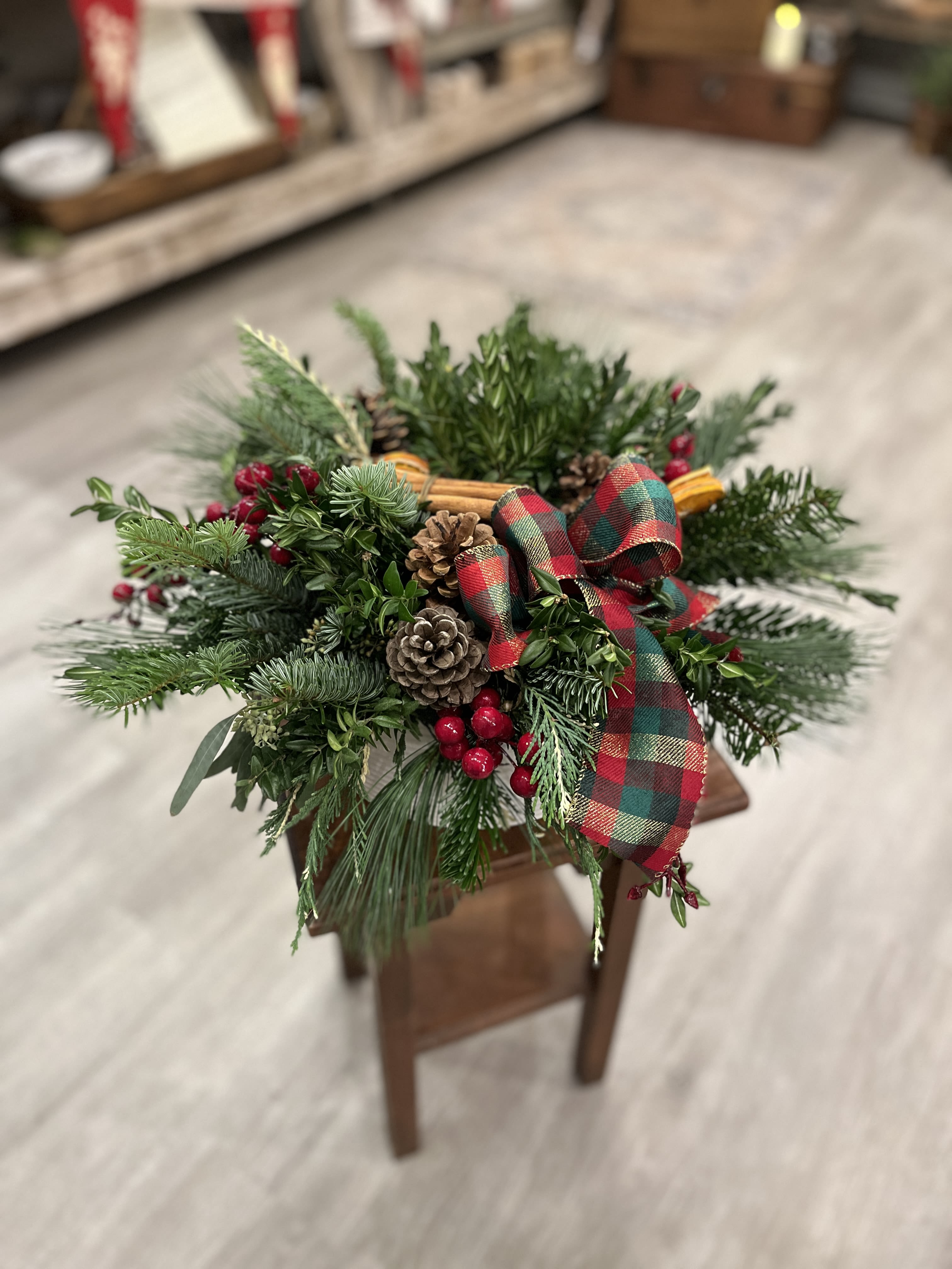 Tidings of Joy  - This lush and full display is an enticing mix of evergreens, pinecones and seasonal trimmings meant to enjoy throughout the holiday season. Simply add water every other day to keep well hydrated and avoid direct heat or overheated rooms.  This bountiful arrangement will last through Christmas Day for all your holiday festivities.  Makes a beautiful corporate gift or gift for the home.  Designed in a low ceramic vessel.   Approx 18&quot; x 10&quot;