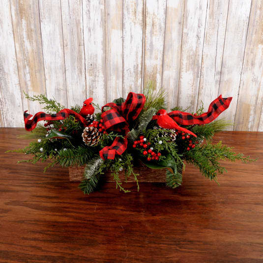 Yule Log Centerpiece-SILK - This rustic wood container comes filled with beautiful lush silk winter greens. A holiday ribbon, cardinals and pine cones add detail to this forever centerpiece.  Perfect centerpiece that can be used year after year, just re-fluff and display.  Approximately: 2 feet long, 10 inches tall 