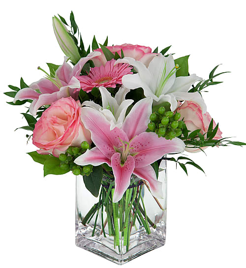 Sweetness and Light  Arrangement  - Our Sweetness &amp; Light Bouquet is a lovely arrangement of soft and fragrant blooms with lush greens and berries, arranged in a clear glass cube vase - featuring delicate two-toned pink roses, pink and white lilies and pink gerbera.