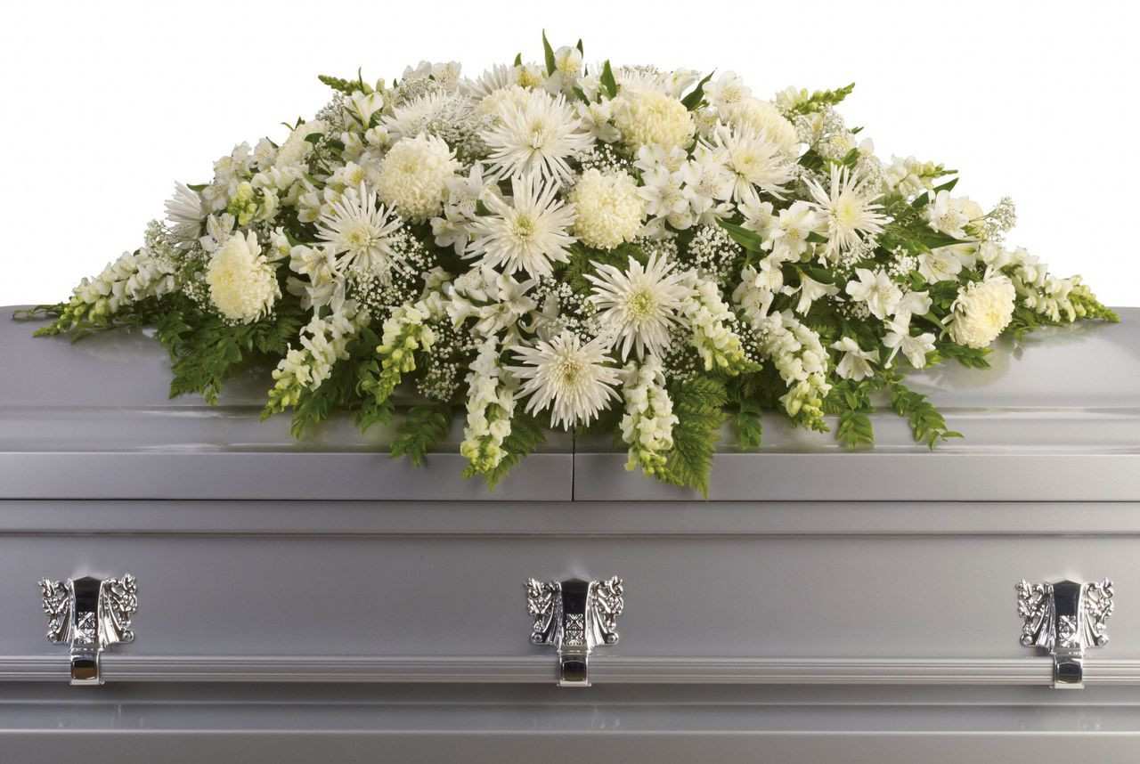 Enduring Love All White Casket Cover Spray -  There’s something about white flowers that exude a sense of purity and peace. We have included a variety of white flowers in this particular arrangement: roses, carnations. snapdragons, Fuji mums, Asiatic lilies, and more. Allow this arrangement to reflect precious memories and bring you and your loved ones peace. 