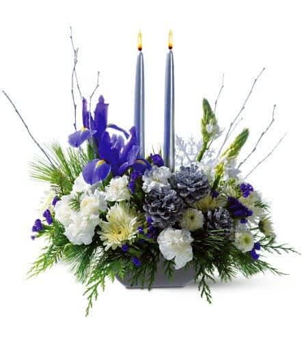 Traditional Hanukkah Centerpiece - This lovely silver, white and blue centerpiece featuring silver candles is ideal for any size or shape holiday table.  A 'rounded square' design dish is the base for this medium size arrangement.  Beautiful blue iris stand out among white roses and white pine.  Elegant, pure, and just right for your family and guests.