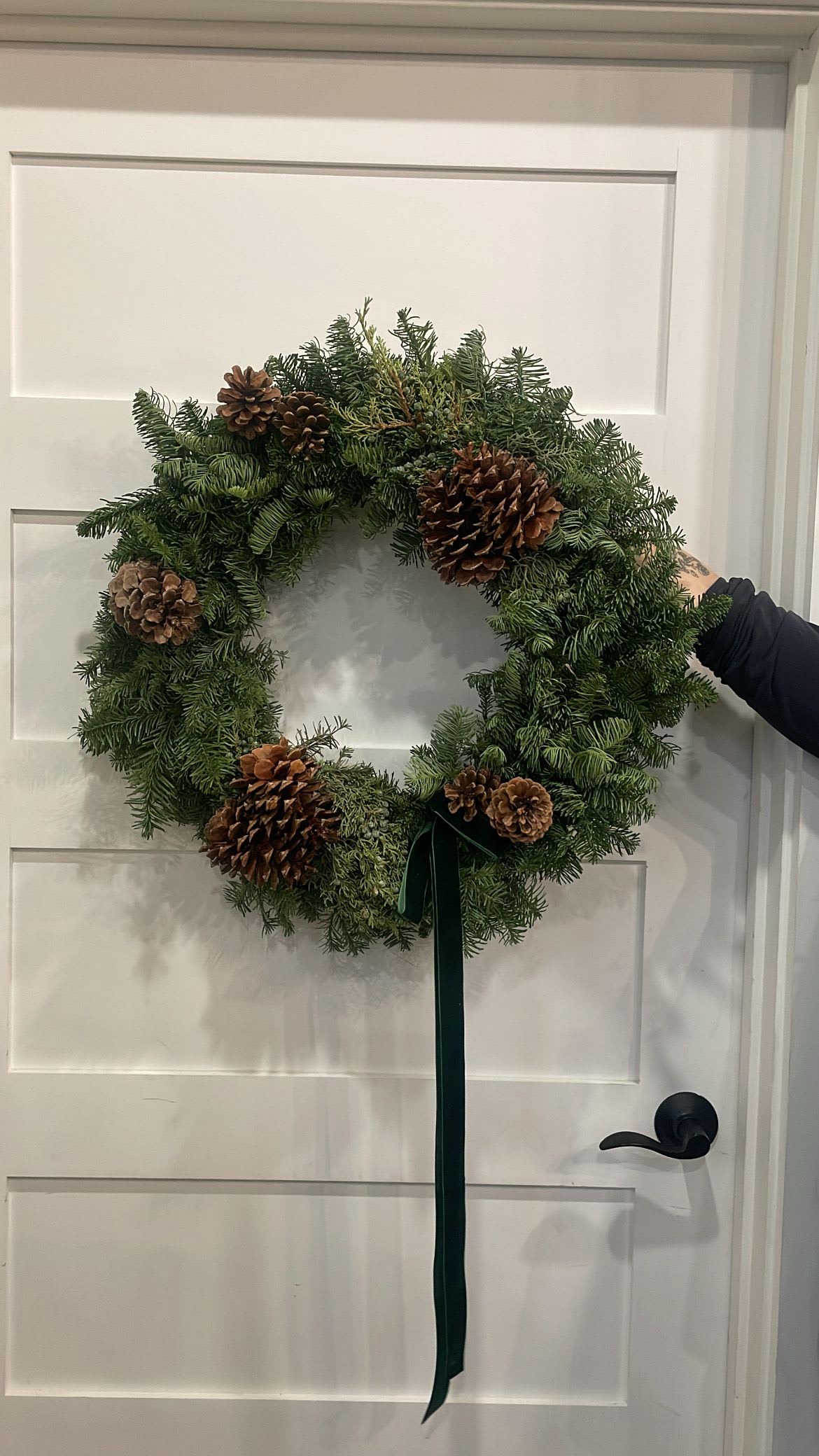 Holiday Wreath - Au Naturale - Deck your door with our Au Naturale Holiday Wreath! Featuring evergreens, juniper, pinecones and topped off with a seasonal bow is just enough without doing too much!  Wreath base is approximately 16-20” If you have a specific color request for the ribbon let us know in the notes and we will do our best to accommodate.