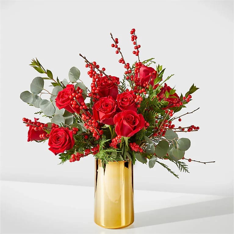 Decembrrr Bouquet  - Striking red roses, berries and delightful holiday greens make for an exquisite way to share a seasonal greeting, anniversary love, or birthday wish!