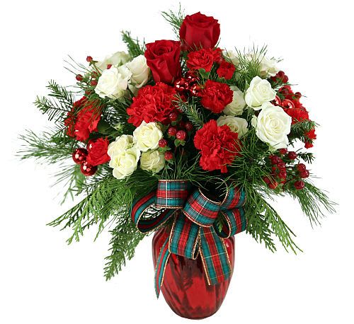 In Love with Christmas  - A red and white Christmas design featuring ample white spray roses and a bevy of Christmas-red miniature carnations, artfully arranged in a red holiday vase with red berries, red ornamental balls and seasonal greenery.