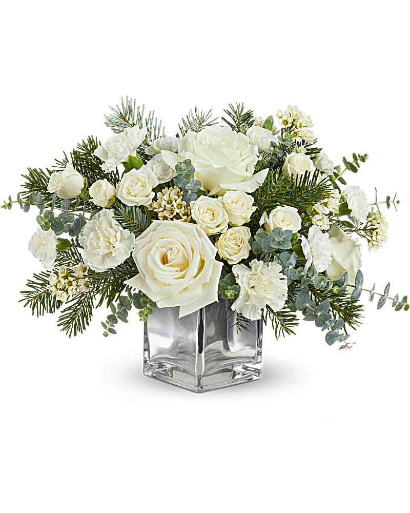 Teleflora's Arctic Blooms Bouquet - Teleflora's Arctic Blooms Bouquet captures winter's serene beauty with snowy white roses, soft winter greens, and seasonal accents in a chic silver cube. A stunning Christmas or winter gift to brighten the season. Teleflora's Arctic Blooms Bouquet includes white roses, white spray roses, white carnations, white miniature carnations, white waxflower, spiral eucalyptus, and noble fir in a silver glass cube Orientation: All-Around