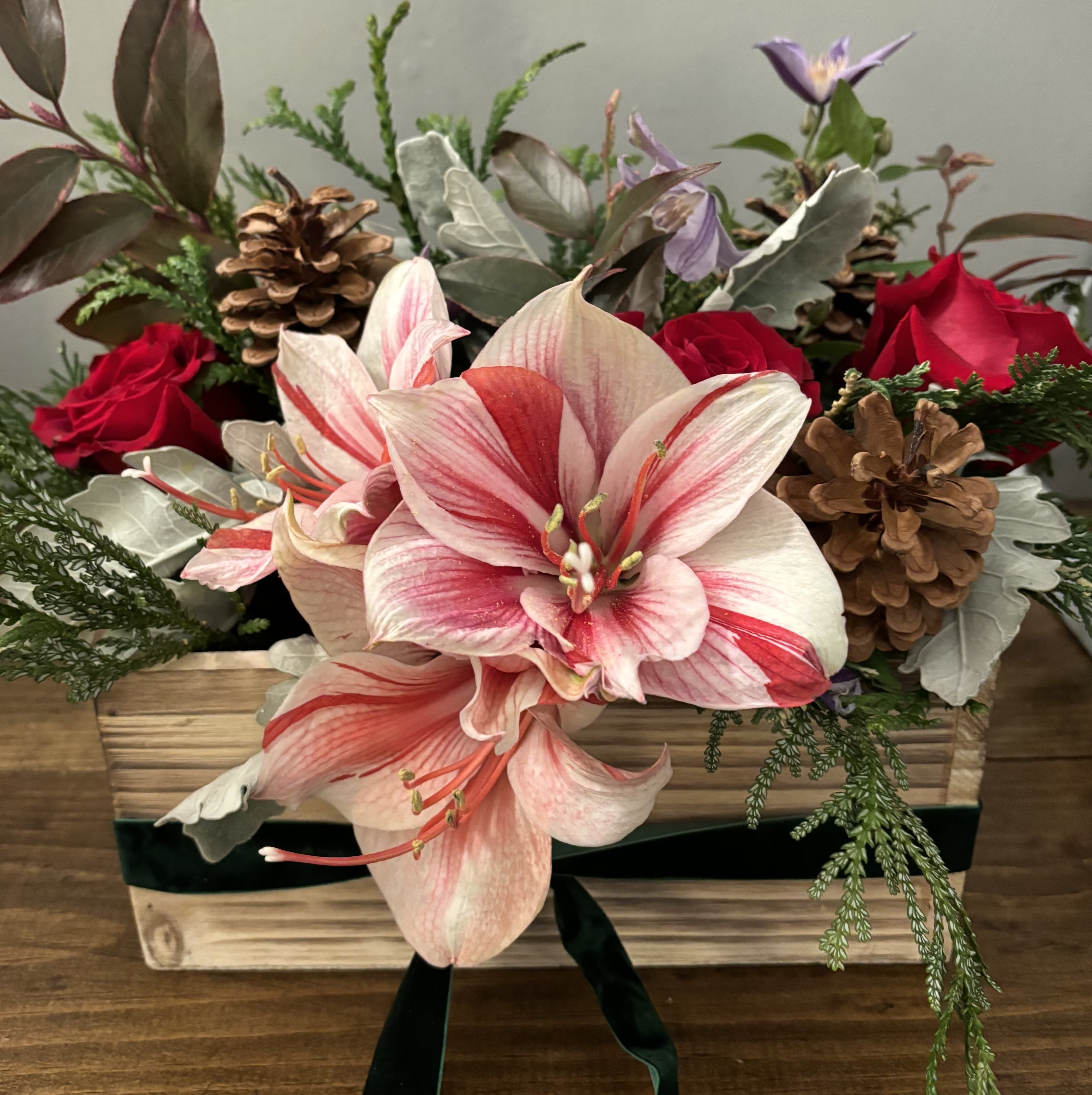 Merry &amp; Bright - This is a holiday classic with a twist. It has all of the elements of a traditional Christmas centerpiece but with touches of purples and natural elements.    Every effort will be made to recreate your chosen design. Please note that from time to time due to product availability and quality we may need to make substitutions. We will make sure to keep the original design in mind when making substitutions.