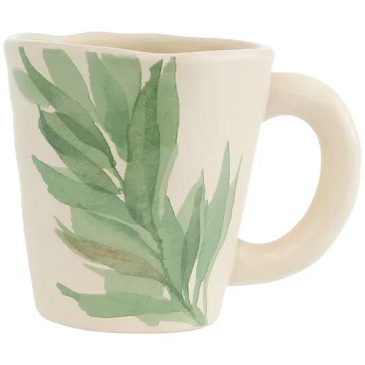 Leaf and Stem Mug - Crafted of durable stoneware, the Leaf And Stem Mug pairs an organic, gently wavy rim and easy-grip handle with calming balance. A painterly green frond sweeps across the creamy surface, bringing a fresh, nature-inspired lift to coffee breaks and quiet tea moments. Approximate dimensions are 5.25 x 3.75 x 4 inches.