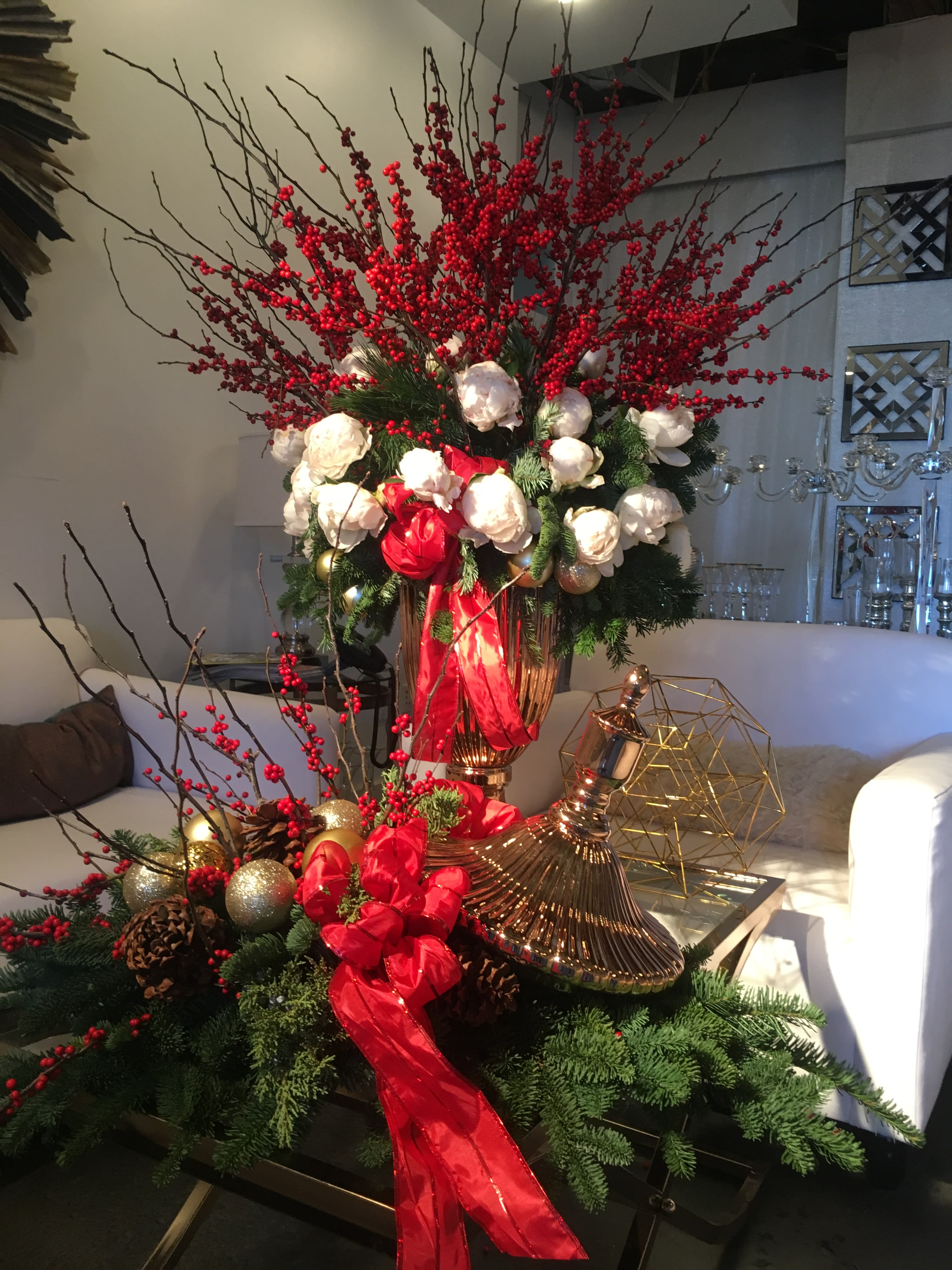 Red and White Christmas - An explosion of red and white in an extravagant two-piece arrangement! This one-sided display is wonderful to welcome guests in an entry, or as a stylish holiday gift to your favorite people. Fluffy white peonies and holiday greens will fill any space with the beautiful fragrance of winter, and sparkling gold ornaments and bright red winter berries will bring the festive spirit in spades!  *Please allow at least 1-day advance notice to ensure the freshest peonies*  Sold as a set or just the single urn (without the lid). Listed price is for single arrangement (see second photo), select &quot;Premium&quot; to order both pieces.  *NOT AVAILABLE SAME DAY*
