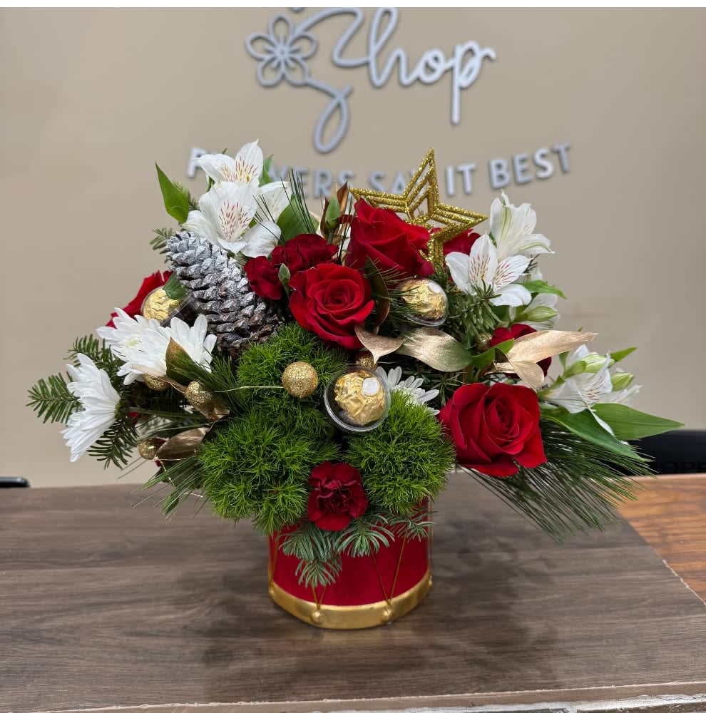 The Sweetest Ornament Feat. Ferrero Rocher - Celebrate this Christmas with our exclusive Katy Flower Shop arrangement. Comes in the ceramic keepsake drum vase with red roses, mini carnations, white alstroemeria, green moss balls, golden ruscus, white cushion daisies and of course the sweetest Ferrero Rocher encapsulated golden ornaments!