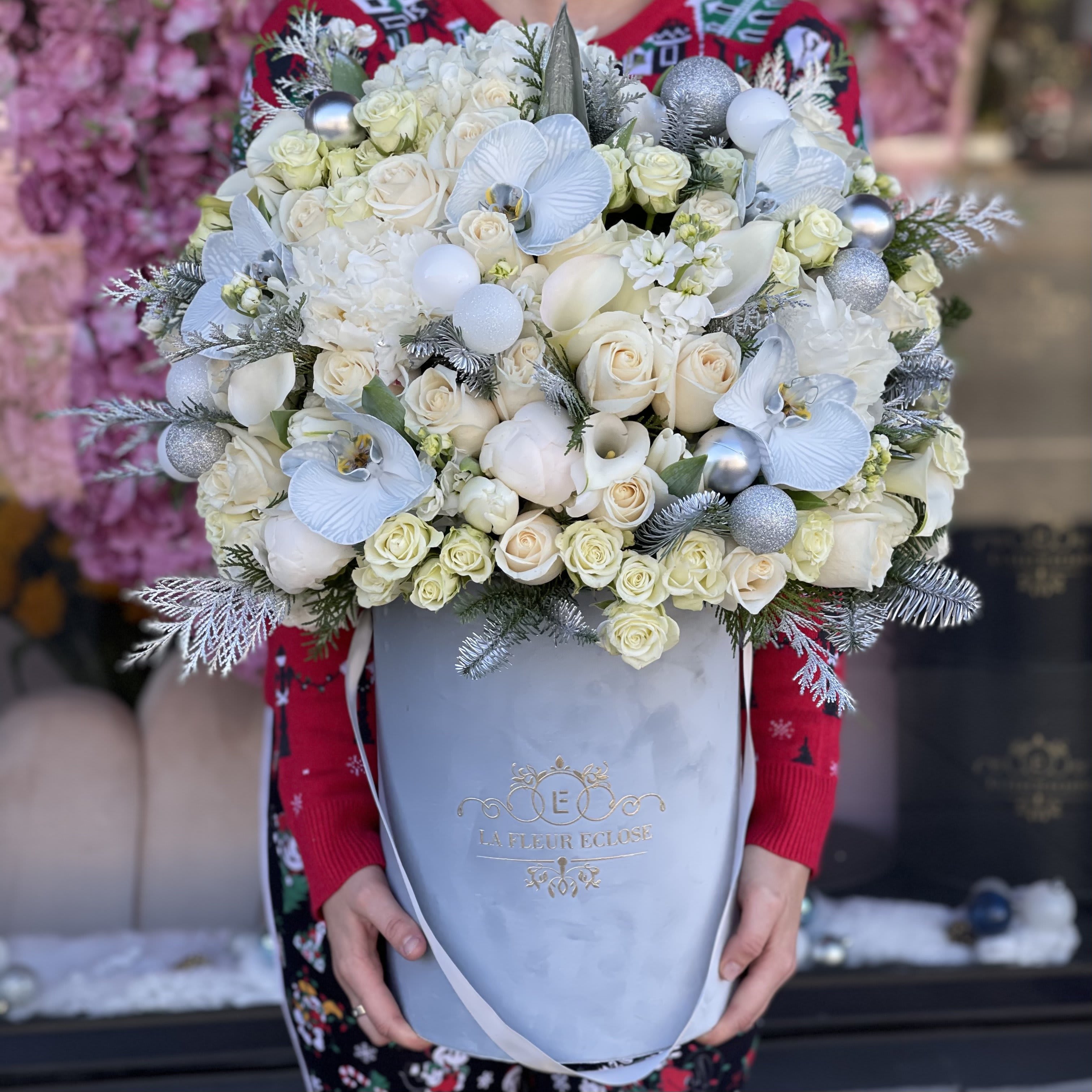 Holiday Beauty  - Beautifully arranged in our grey box with Christmas ornaments  Standard – pictured  Deluxe – the amount of flower will be bigger. We will also put more premium flowers into the arrangement. Premium – the box size will be changed for the bigger one and a lot of premium flowers will be added to the arrangement.  