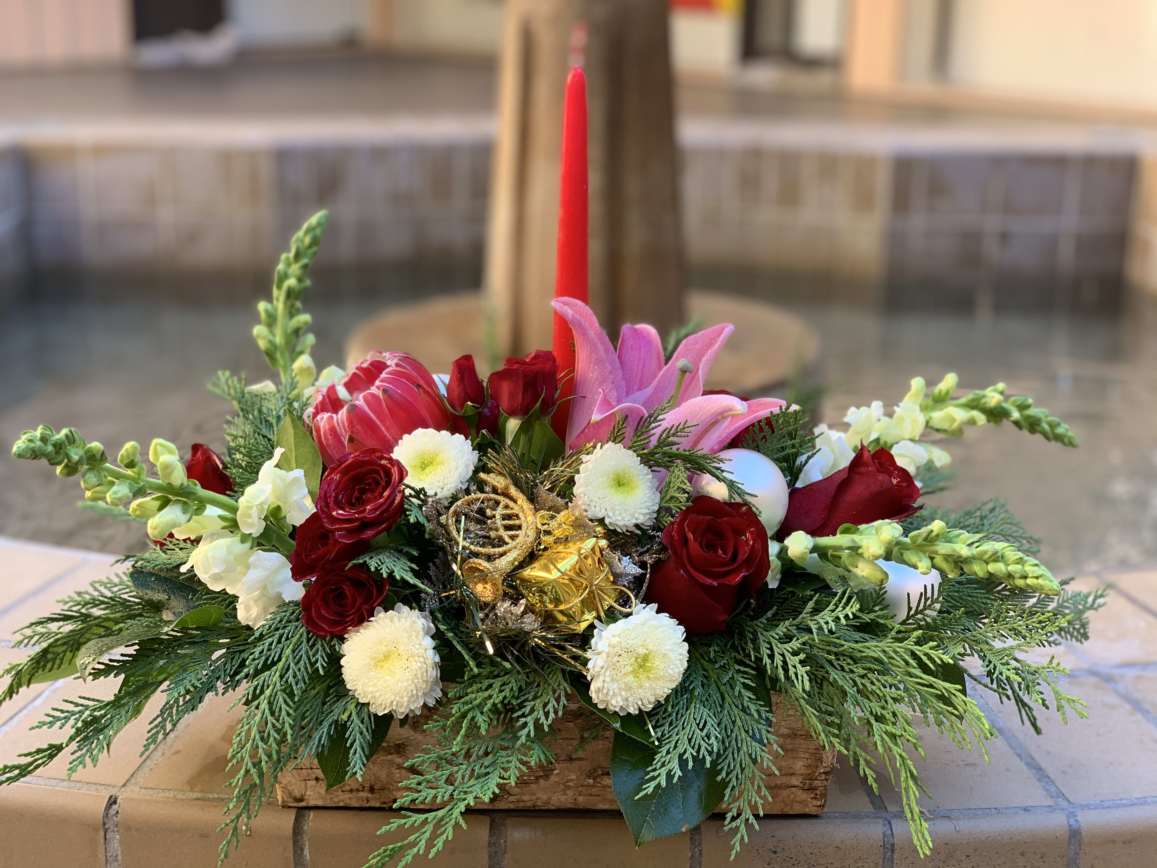 Holly Jolly  - It’s still time to spread the holly jolly Christmas wishes, with this stunning mix of blooms in a beautiful centerpiece.